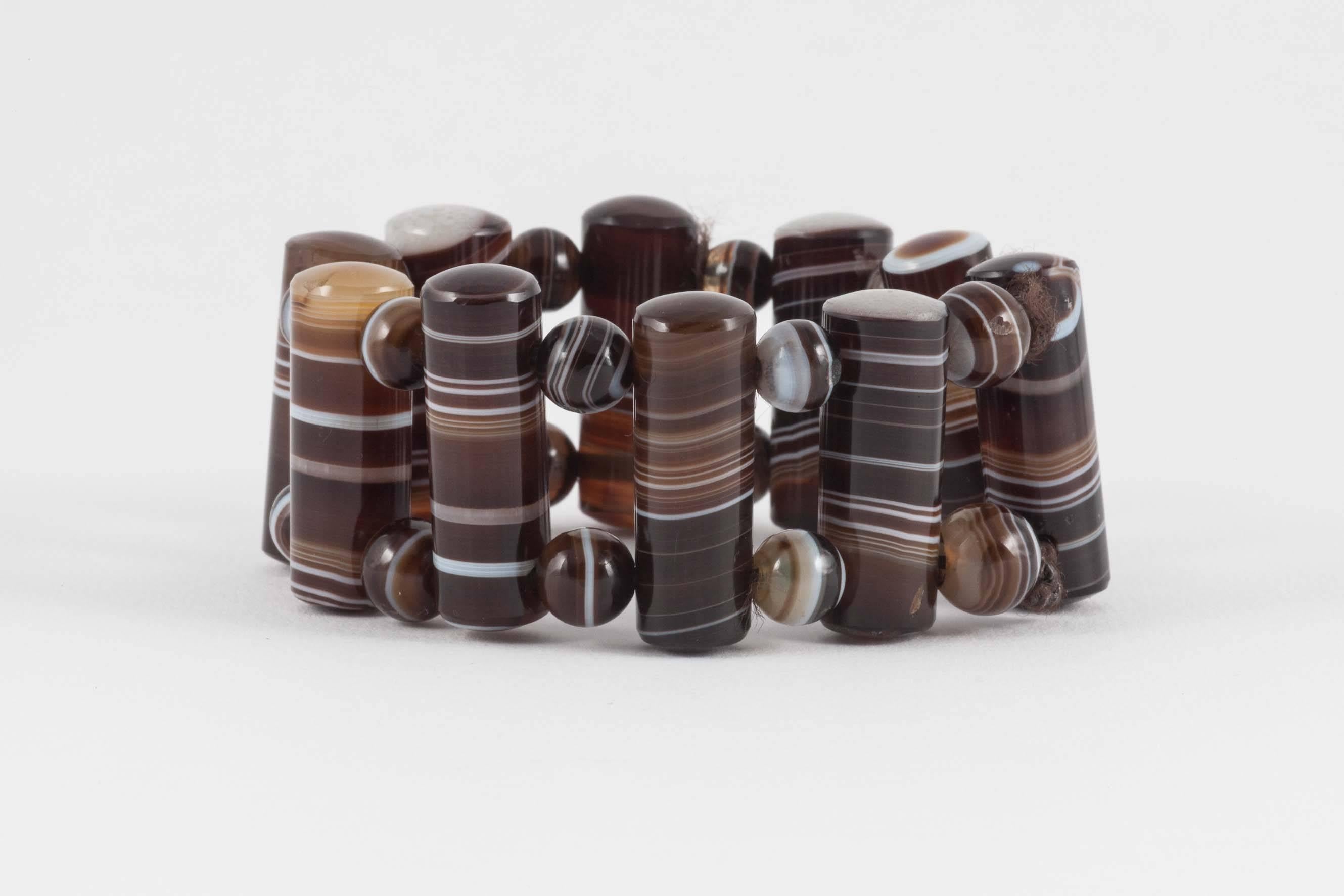 A lovely rich brown agate bracelet with a very tactile quality. The agate rods and beads show a pleasing mix of colours from black to brown, yellow and gray.  It creates a very harmonious composition. This bracelet benefits from being strung on