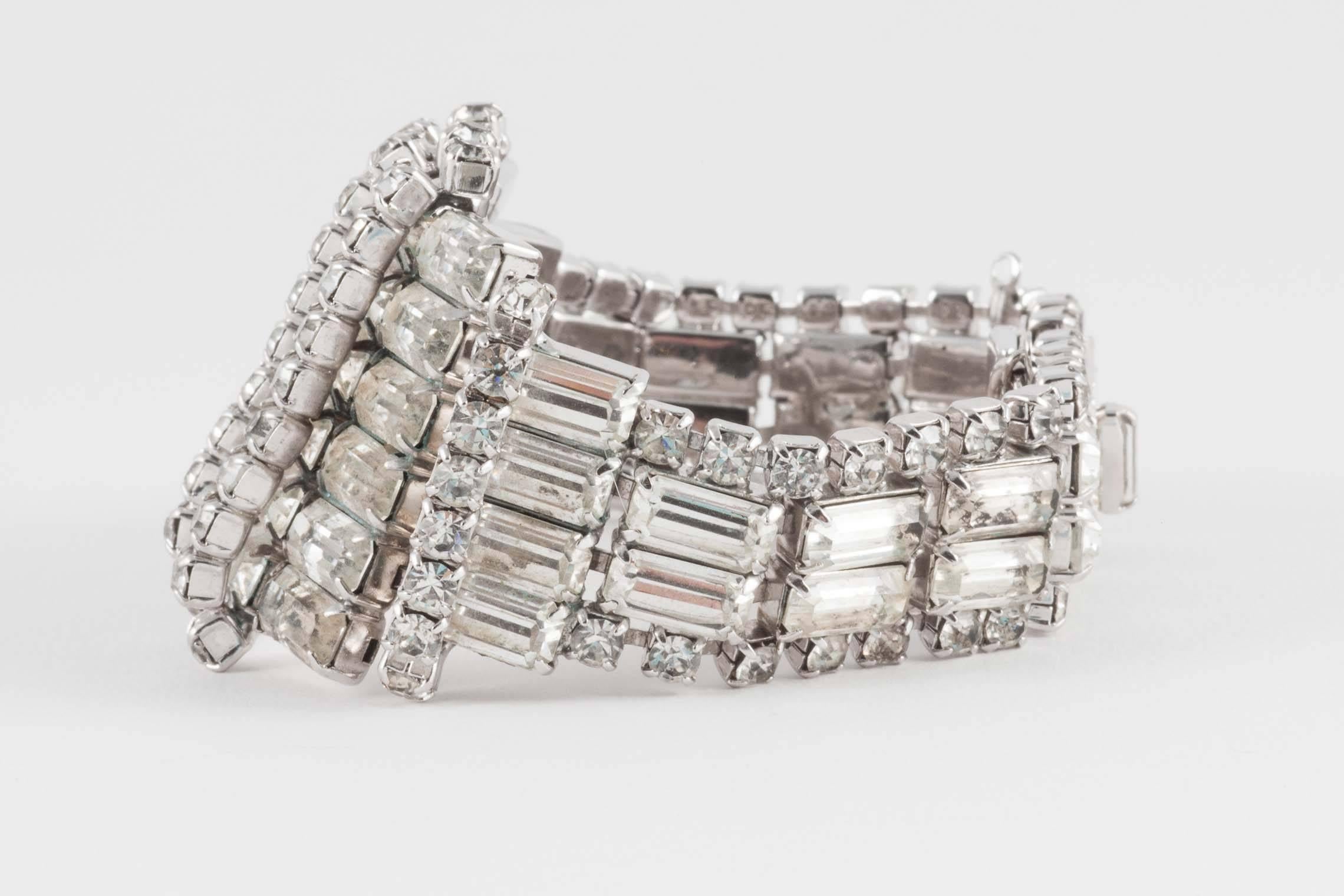 This wonderfully designed bracelet makes a strong statement. Probably designed to be worn over gloves, it is a good size for even a bigger wrist, and is ready for the party season. It has a working safety chain so you won't lose it!