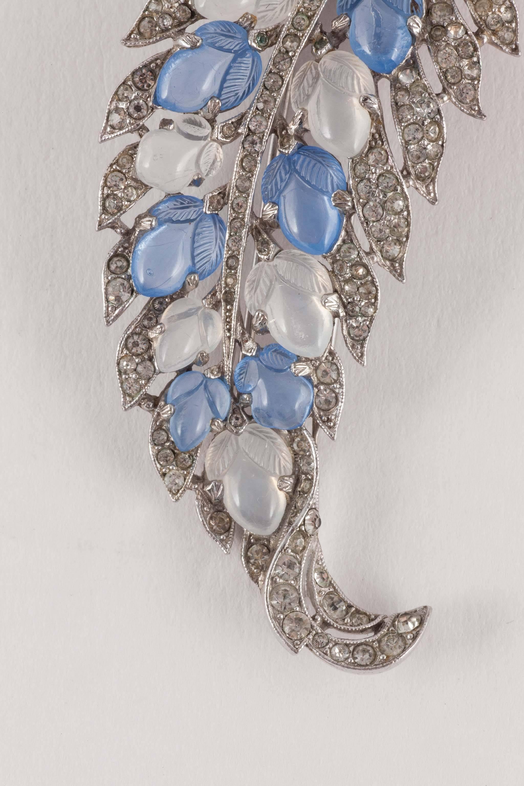 Elegant , stylised brooch (with fur clip fitting) in the form of a 'leaf' , set with 'fruit salad' moulded glass stones, in moonstone and blue chalcedony glass, and paste. Based on iconic Cartier jewels from the 1930s, the Trifari 'fruit salad'