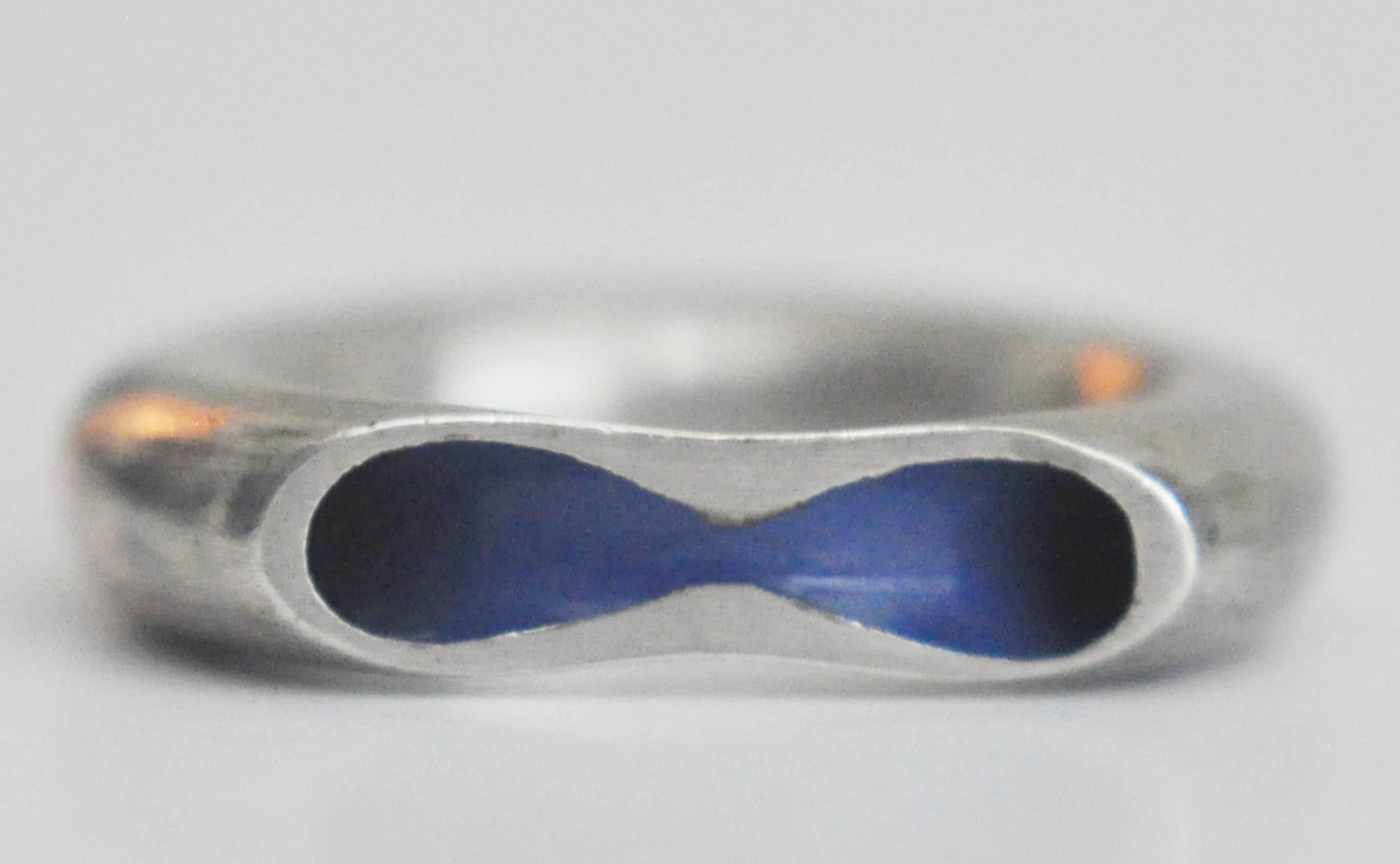 A brilliantly designed ring by the influential designer Marc Newson for the Dutch company Chi ha paura (chp. . .?)  The innovative design is a slice of a hollow silver tube revealing a blue enameled interior. Unmarked.  

Ring size:  7

