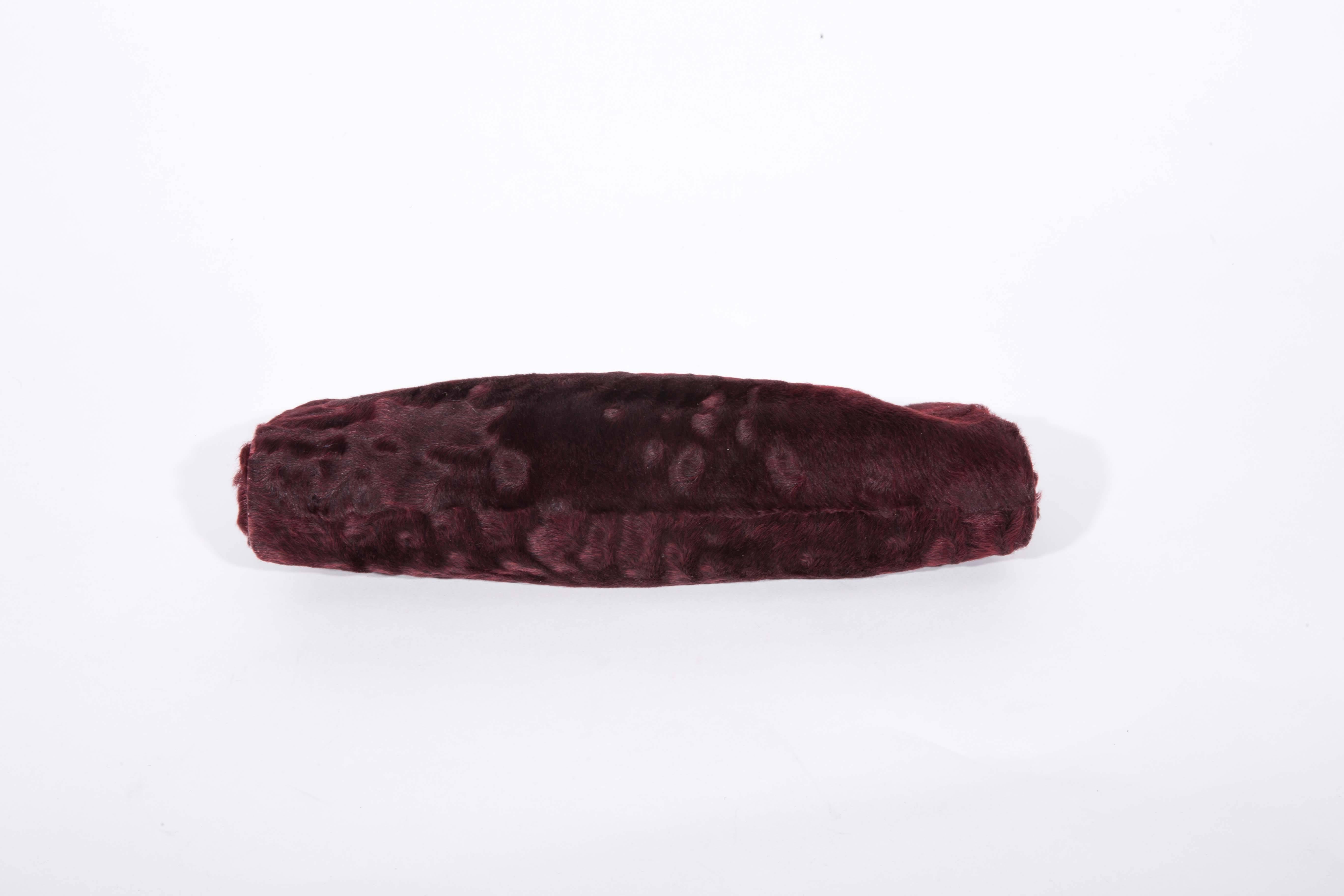 Gorgeous Dennis Basso genuine fur clutch with gold chain shoulder strap. This clutch is trimmed in wine colored snakeskin and closes with a large faceted crystal. Interior and Exterior of this bag are in excellent condition. Bag measures 12 inches