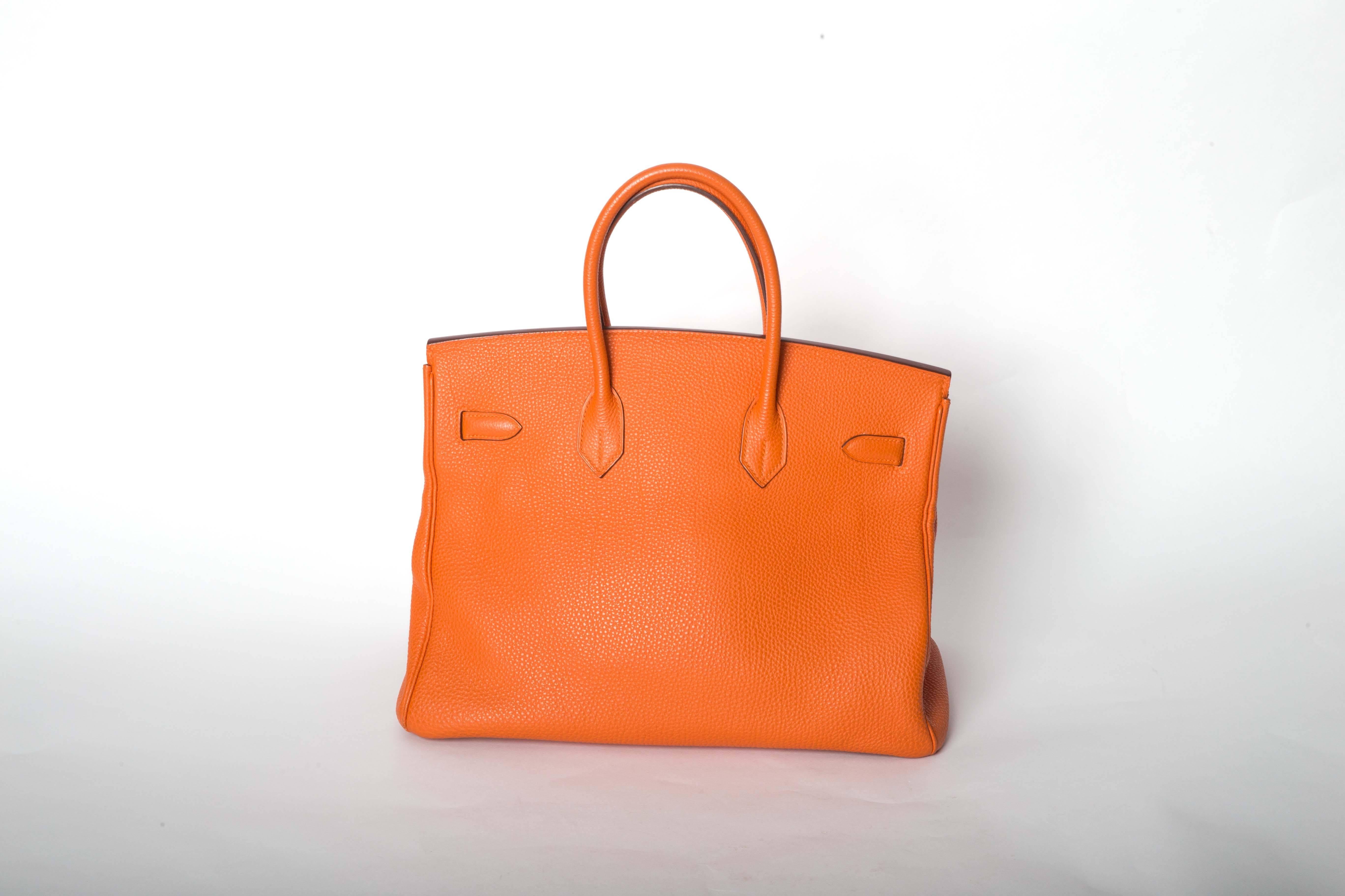 Fabulous Orange 35 cm Birkin with Gold Hardware. This Birkin is in Excellent to Very Good Condition with minimal wear to corners. The hardware is near excellent condition with the plastic film still intact on two of the three front pieces. Interior