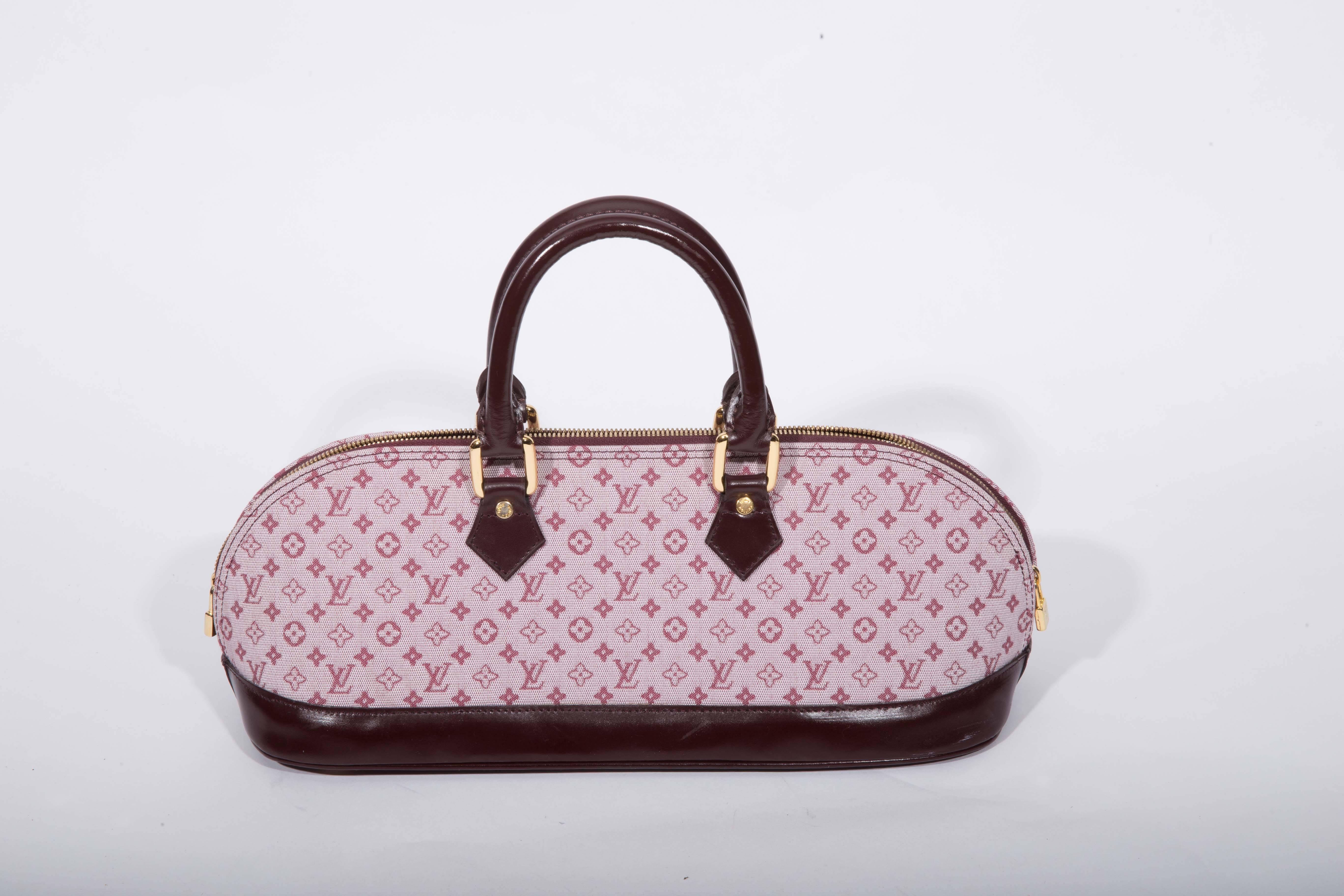 Stunning Louis Vuitton Red Mono Mini Lin Alma Long. This bag is in excellent condition and features dark leather trim and top handles. 