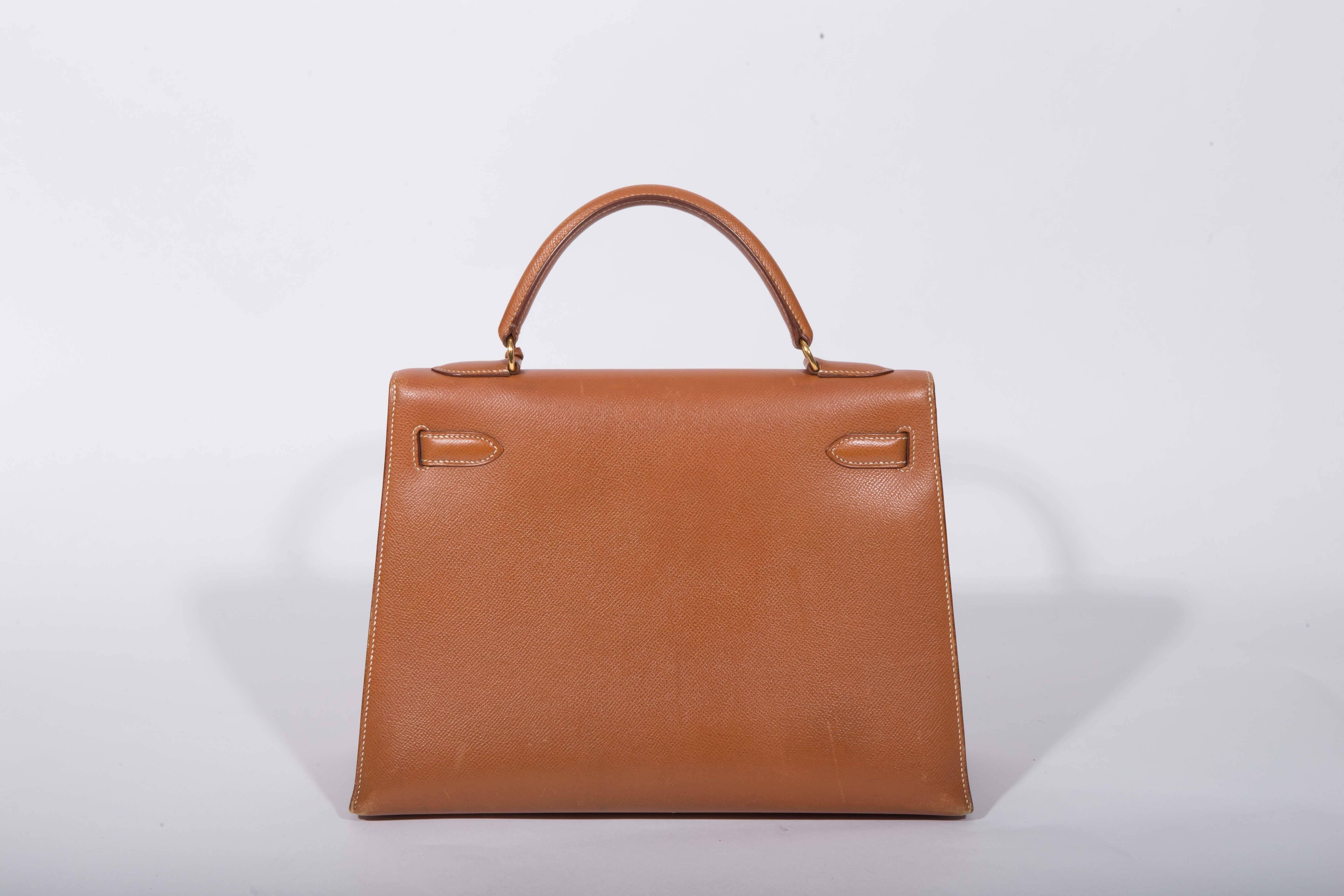 This Hermes Kelly is simply stunning. It was purchased at Hermes' shop on Bond Street, London in 1988 and we guarantee its authenticity. The condition is very good. There are some scratches to gold hardware and scuffing to the corners. Interior is