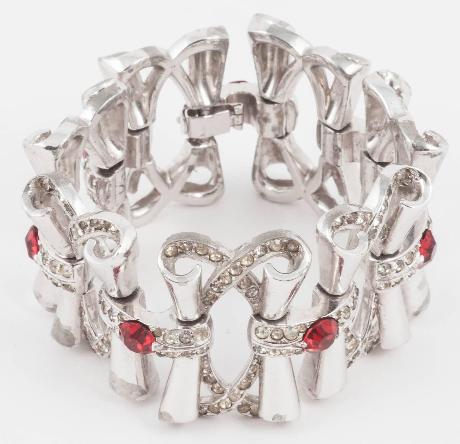 This is a lovely, bold but flowing design in classic 1950s mode. Worn over black gloves it is such a classic look. On a slightly larger modern wrist, it would look great with a jewel sleeved sweater or jacket. Sparkly winter cheer for your wrist!   