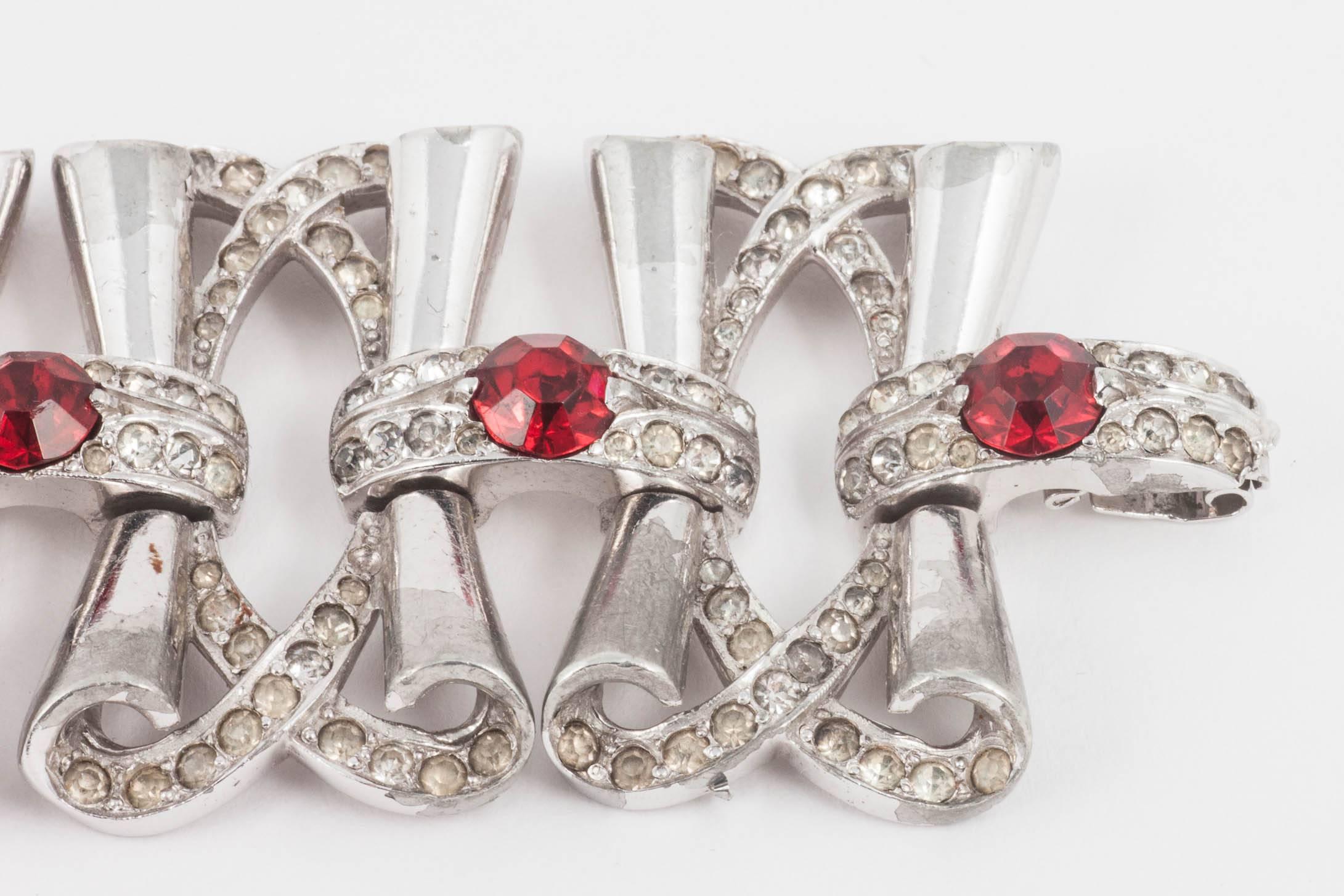 Fluid rhodium plated cocktail bracelet with clear and red paste accents, 1950s 1