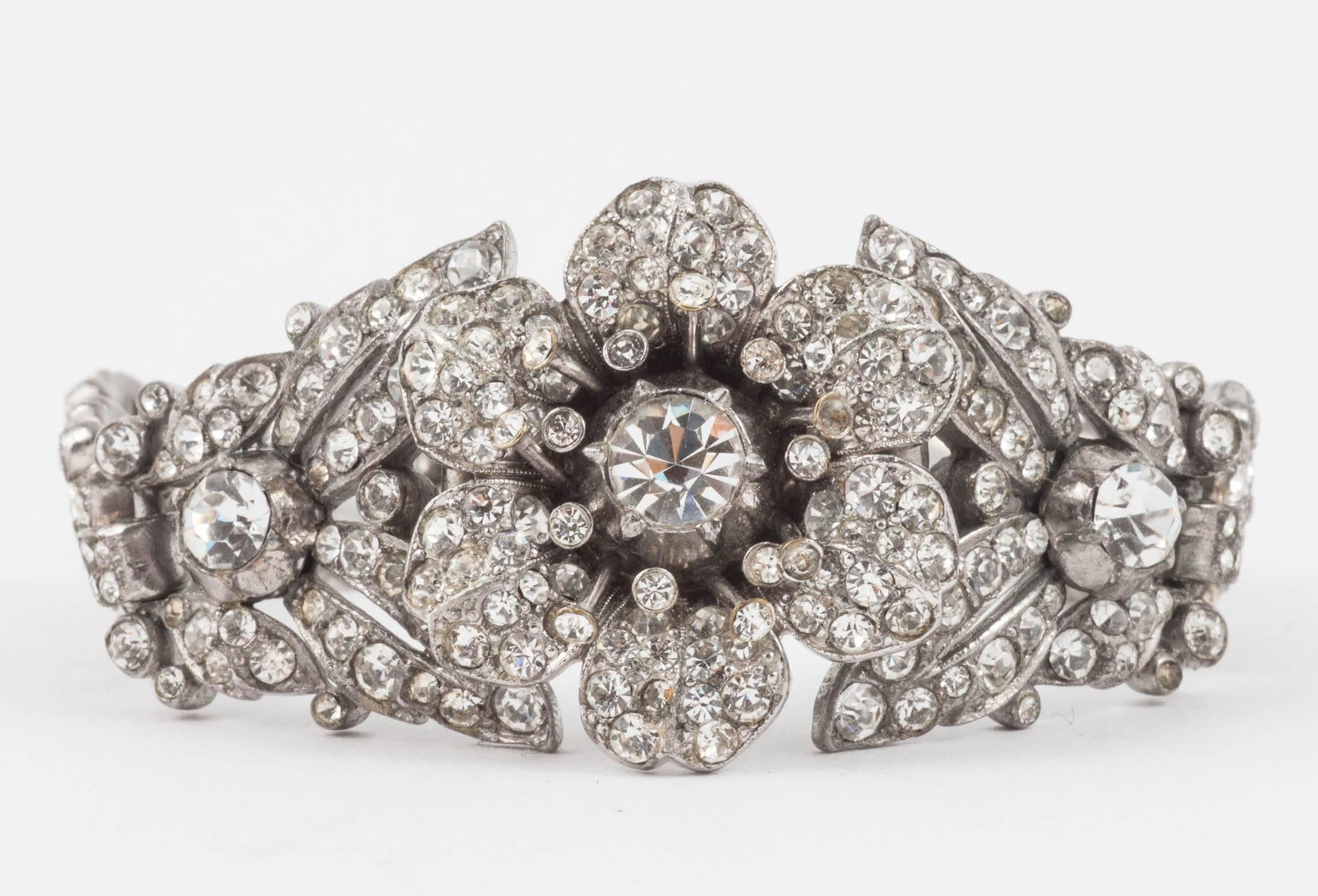 Charming , wearable paste bracelet designed by Alfred Philippe for Trifari, in the 1930s, Art Deco floral in style with an older period charm. Although unsigned, this is a typical and celebrated Trifari design from this period.
The firm of Trifari 