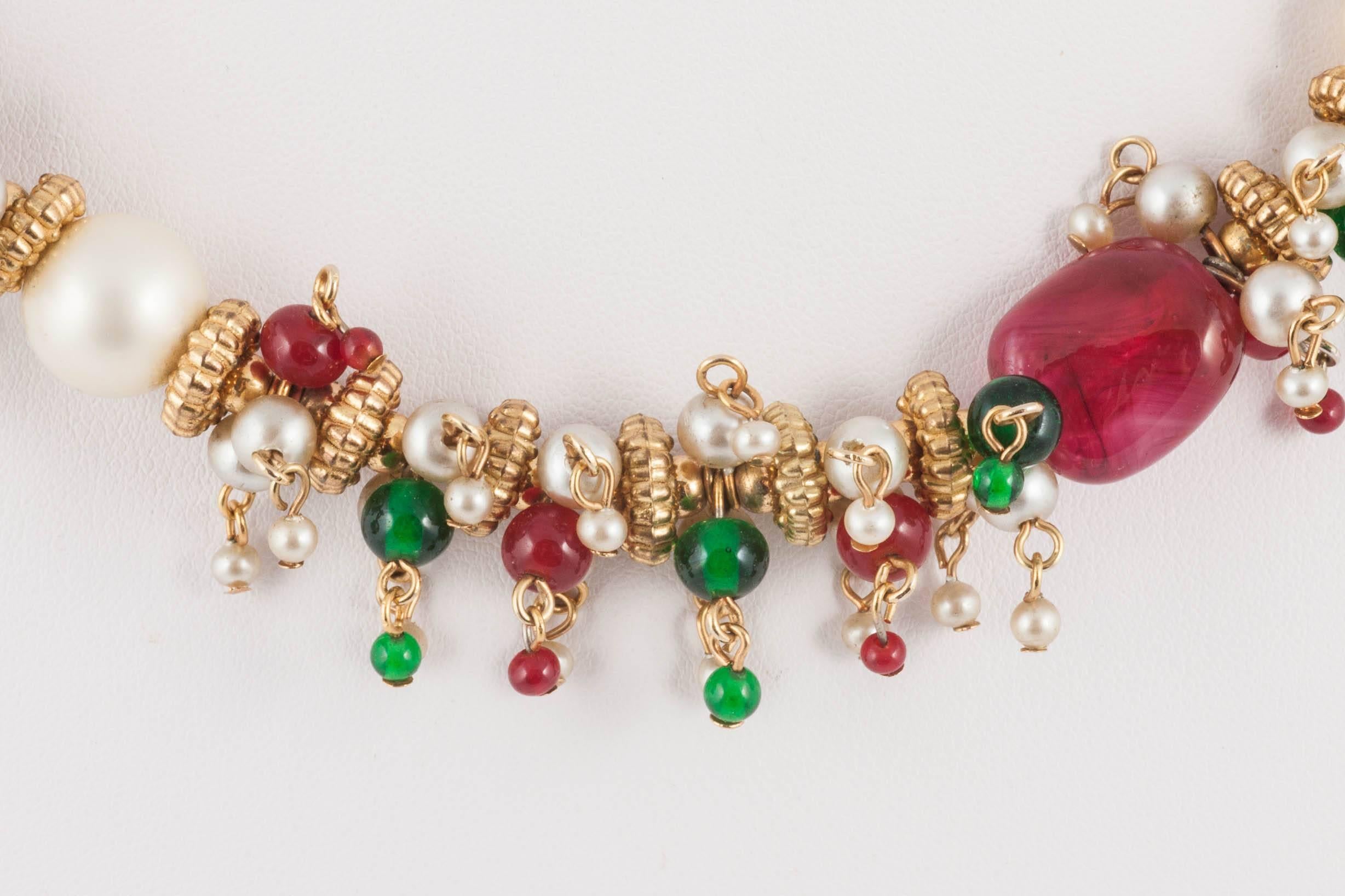 A short but sumptuous necklace , made from poured glass larger rubies and emeralds, with small rubies,emeralds and pearls interspersed in between, with smaller glass beads dangling and highlghting.
Wearable and highly collectable, this beautiful