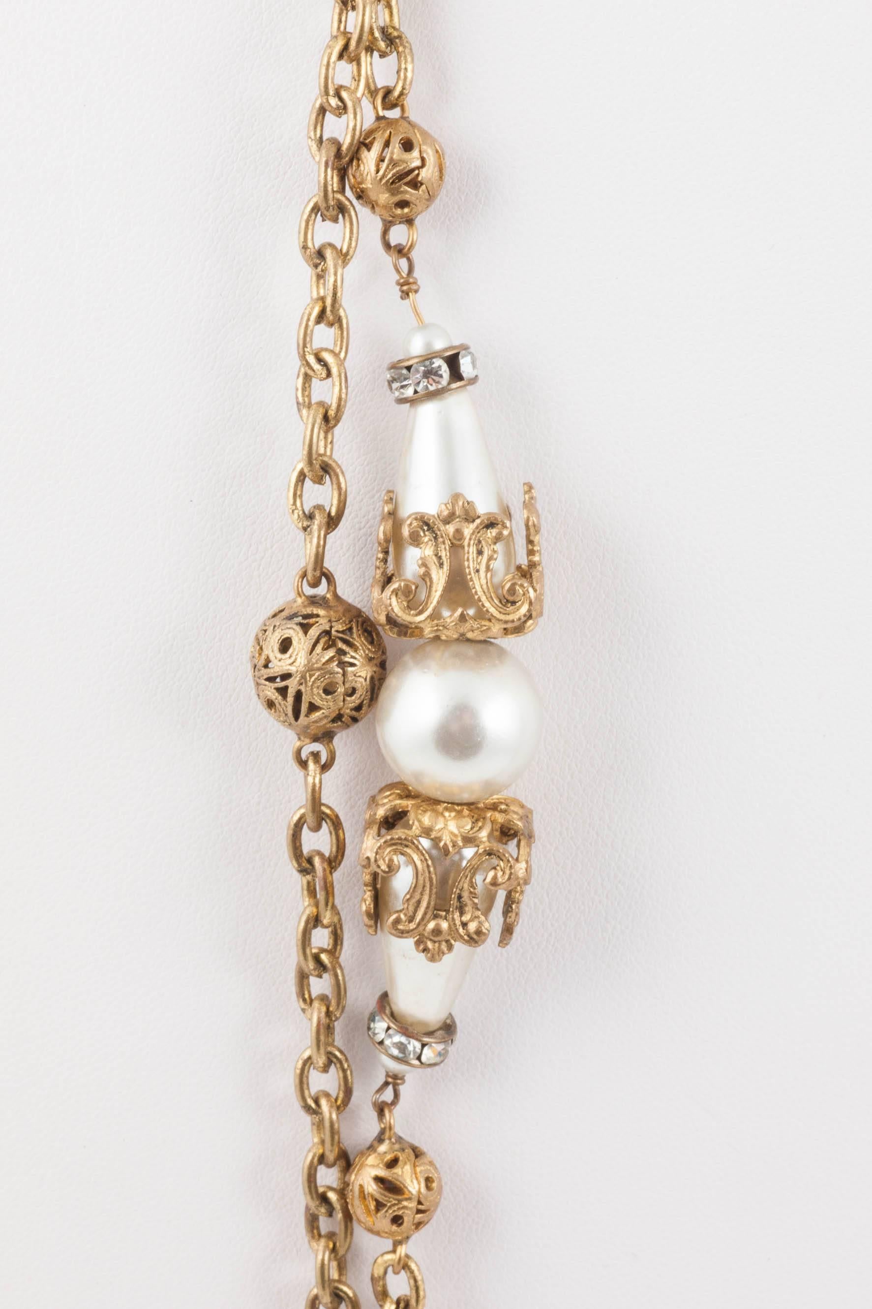 An iconic and very collectable  (and very long) pearl, gilt and paste rondelle chain necklace, handmade by atelier Goossens, with all the composite pieces. This necklace can be wrapped round several times or else worn at its full length.
This