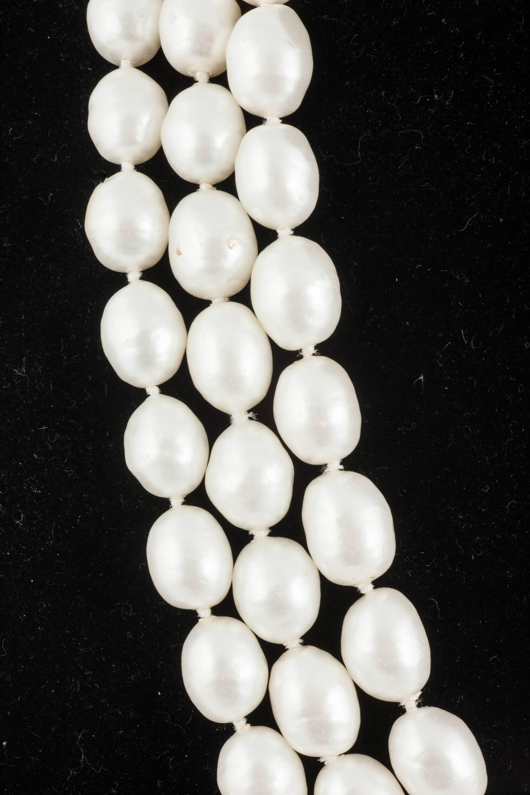 Lustrous and beautifully baroque pearls, signature Goossens, in three rows, one atop the other,  great a striking and classic necklace, attributed to Chanel, in her familiar and iconic style, made in France in the 1950s/1960s.
Although a heavy