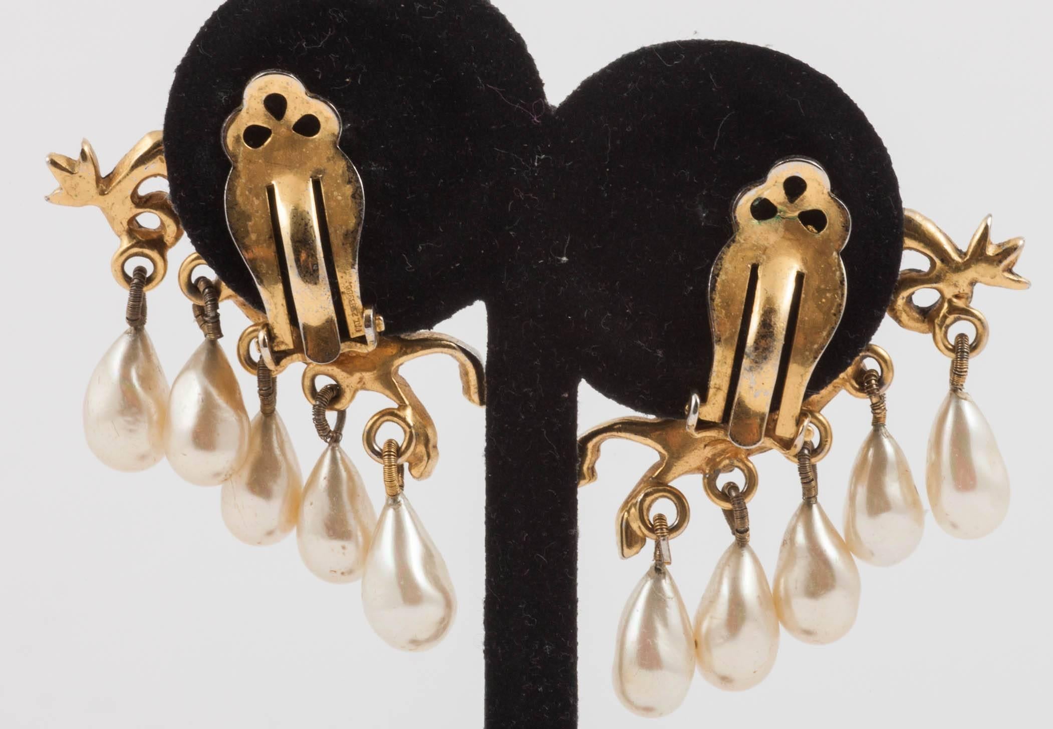 Beautiful cast gilt earrings by Mitchel Maer for Christian Dior, in the form of mythic 'hippocamps', (flying horses with fish's tails), with drop baroque pearls, and brushed in a black patina, from the early 1950s, and from an original French