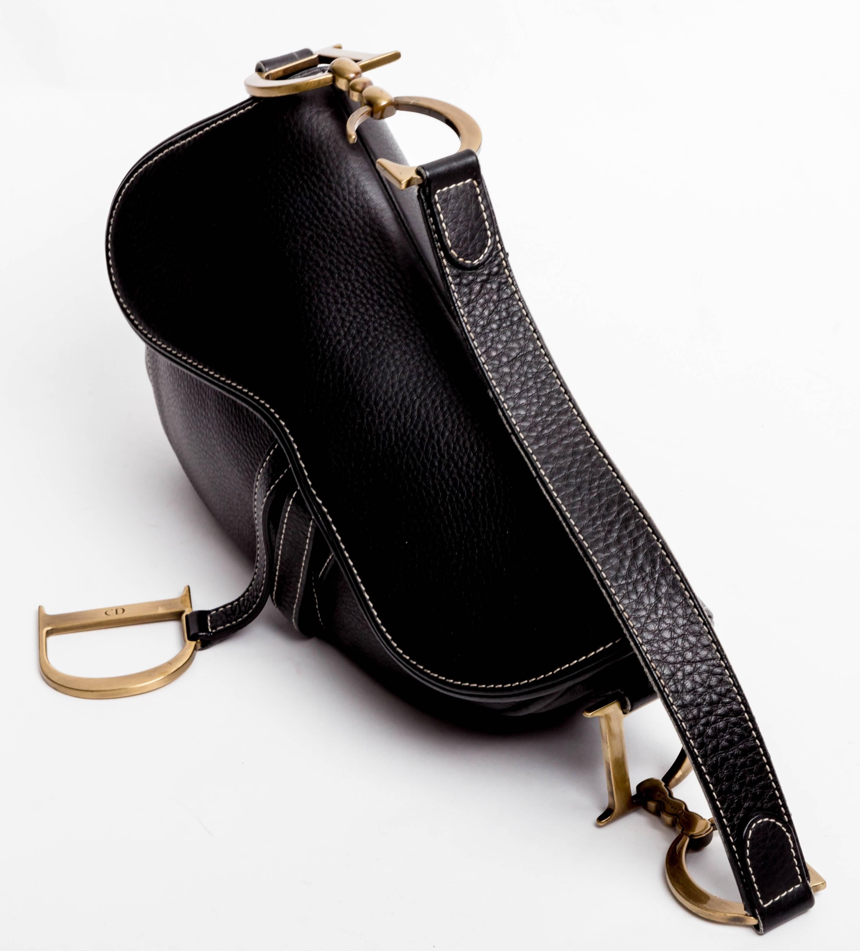 Iconic  Christian Dior Saddle Bag in Black Leather. Closes with an invisible velcro fastening. Condition is excellent both inside and out. One inside zip pocket.