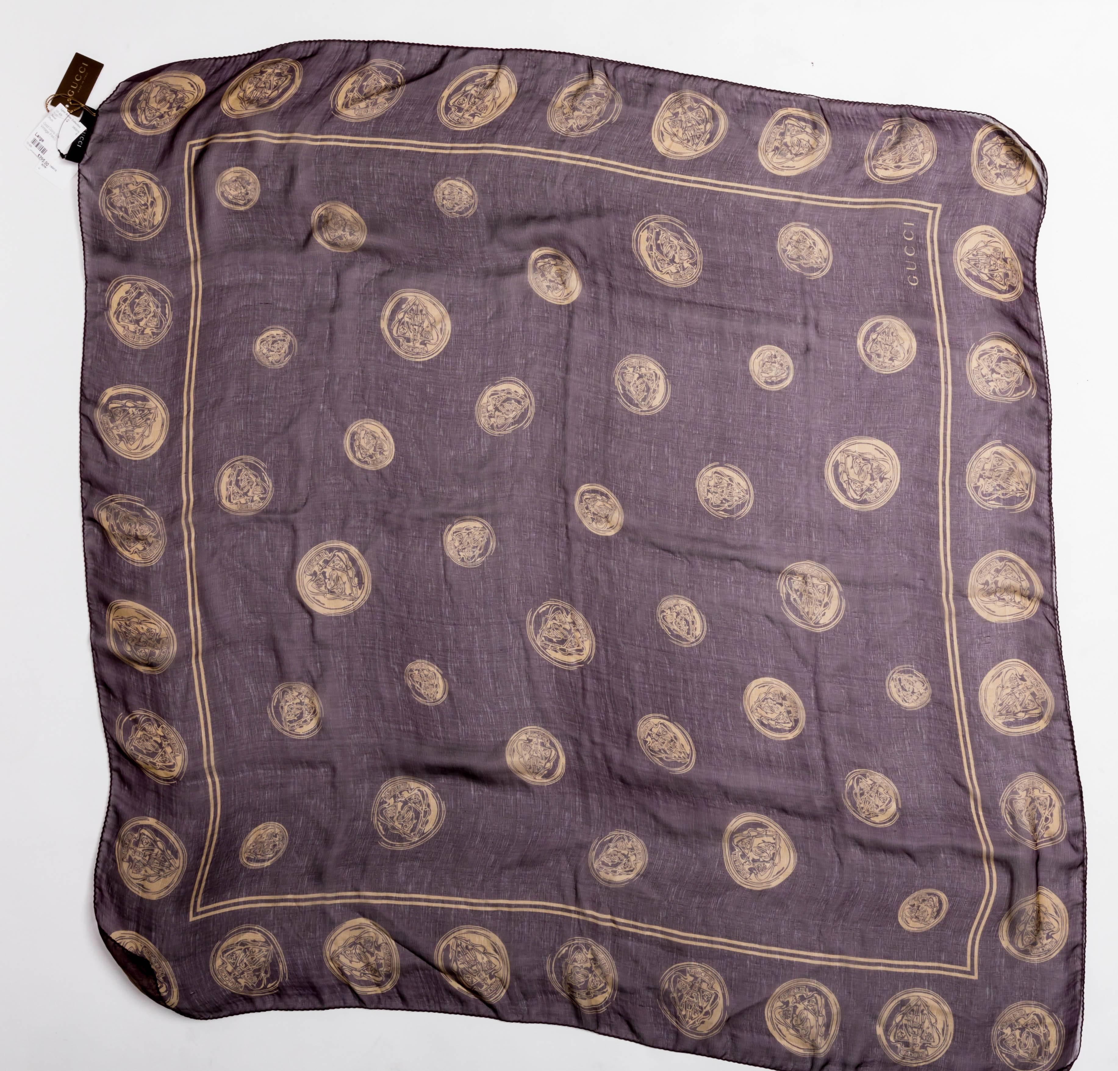 Wonderful vintage Gucci scarf in aubergine with gold coins featured throughout. This scarf has never been used and its original Gucci tags are still attached.
