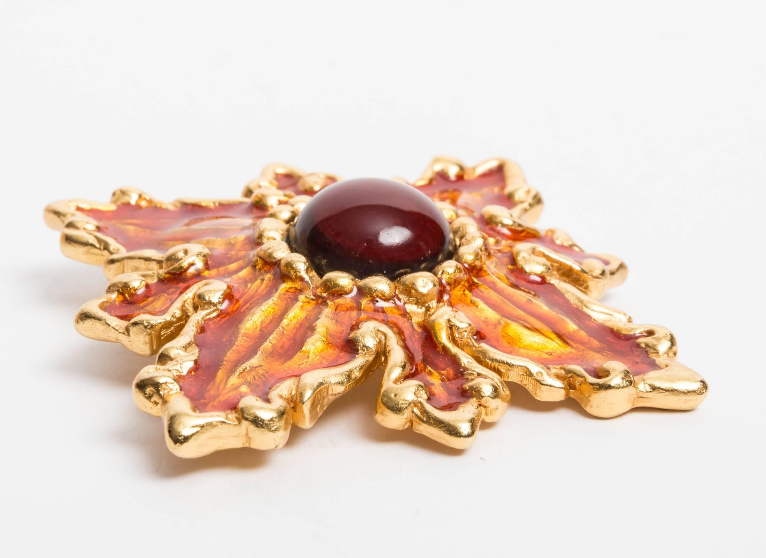 Vintage Signed Christian Lacroix Gold Metal and Amber Glass Pin. Features one large cabochon bead to center with poured glass surround.
We are also selling the matching earrings.
