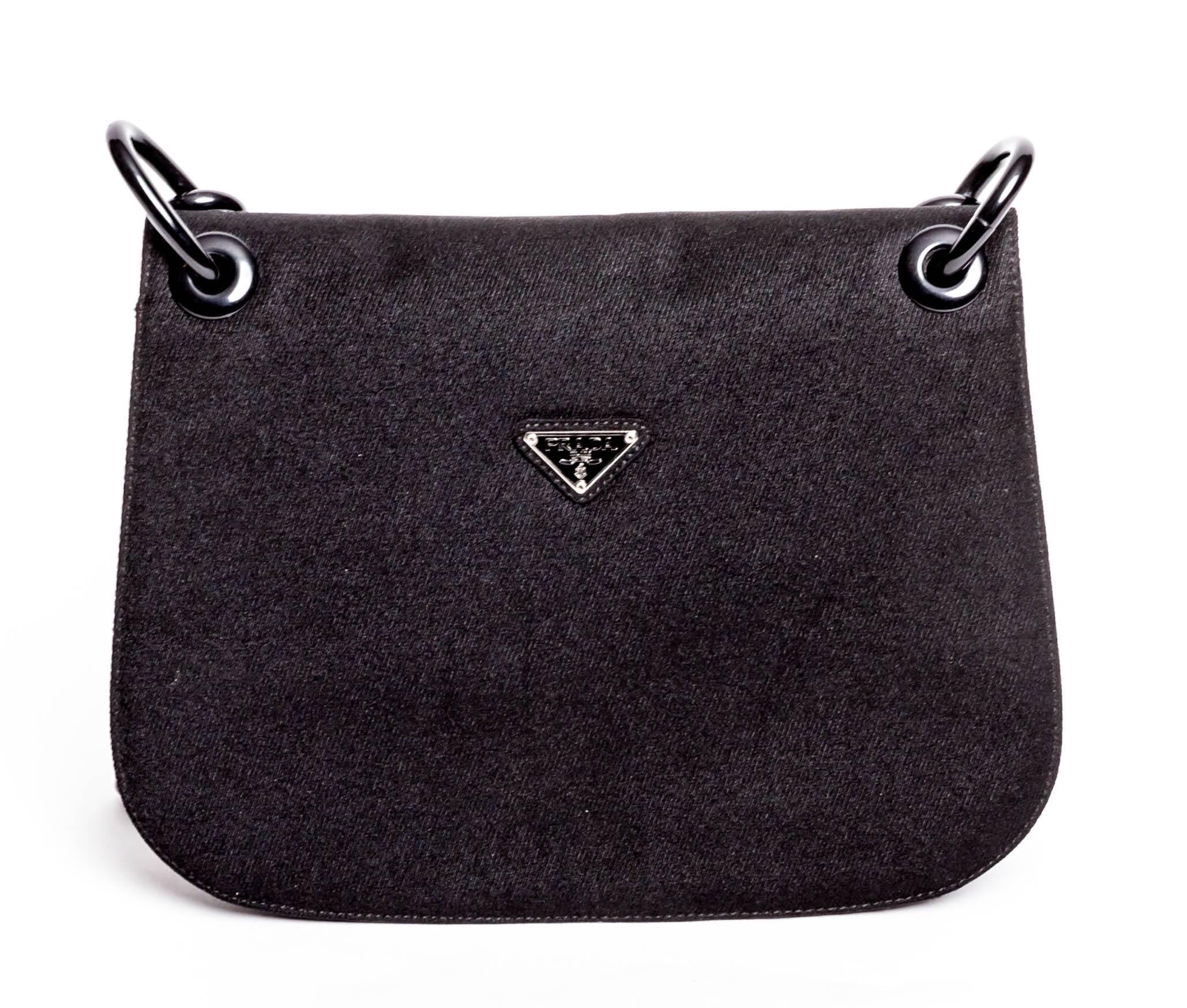 Structured Prada Black Nylon Shoulder Bag with Resin Black Chain Handle. This bag has two large interior compartments, one with a zip pocket. The original Barneys tag is still attached. Includes Prada Authenticity Certificate Card. This vintage bag