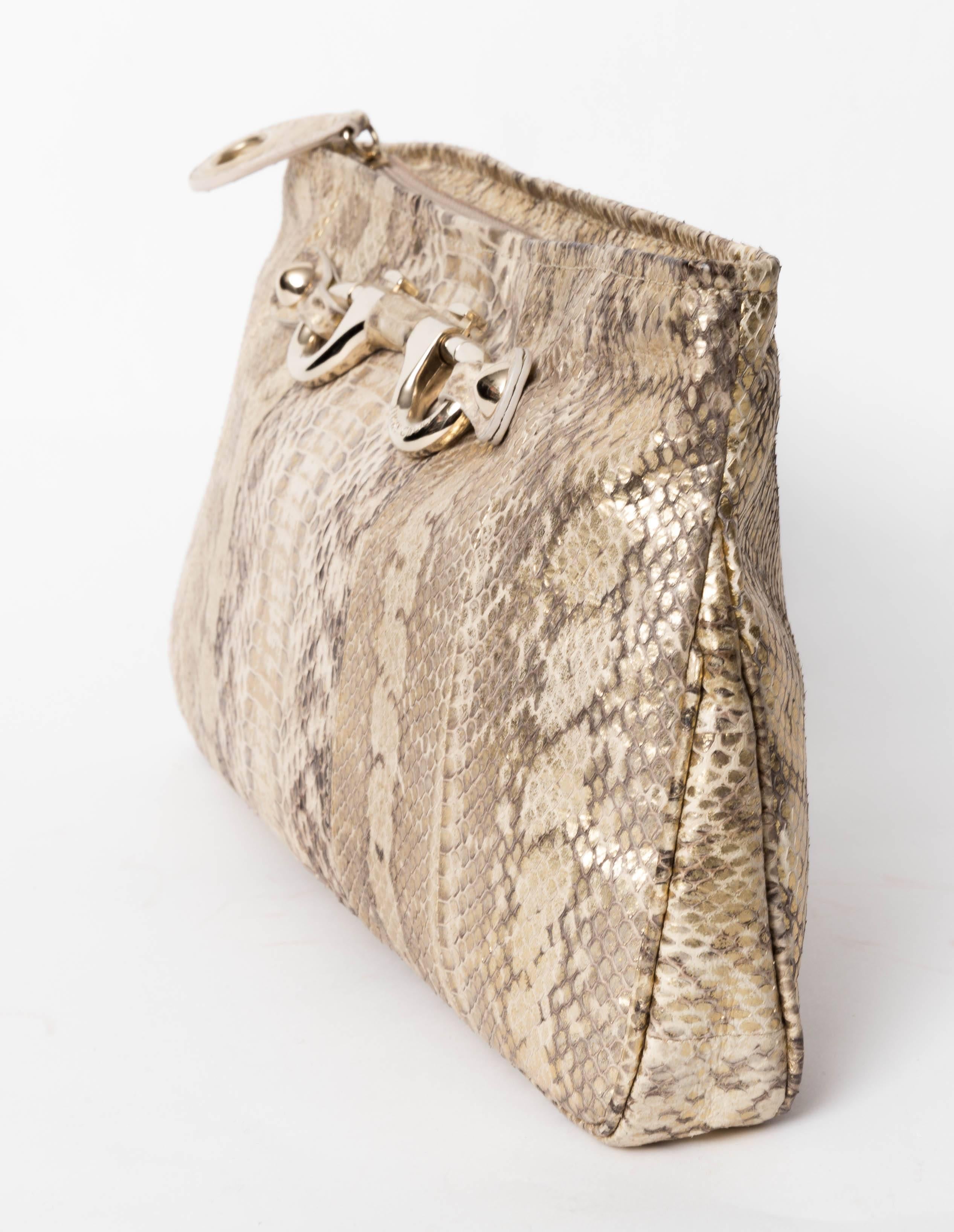 Jimmy Choo Gold and Tan Snakeskin Clutch with Silver  Horsebit Detail. Closes with a zip ending in a snake tab pull.  Lining is a gold grosgrain ribbon with one flap pocket. There are makeup stains to the lining. 