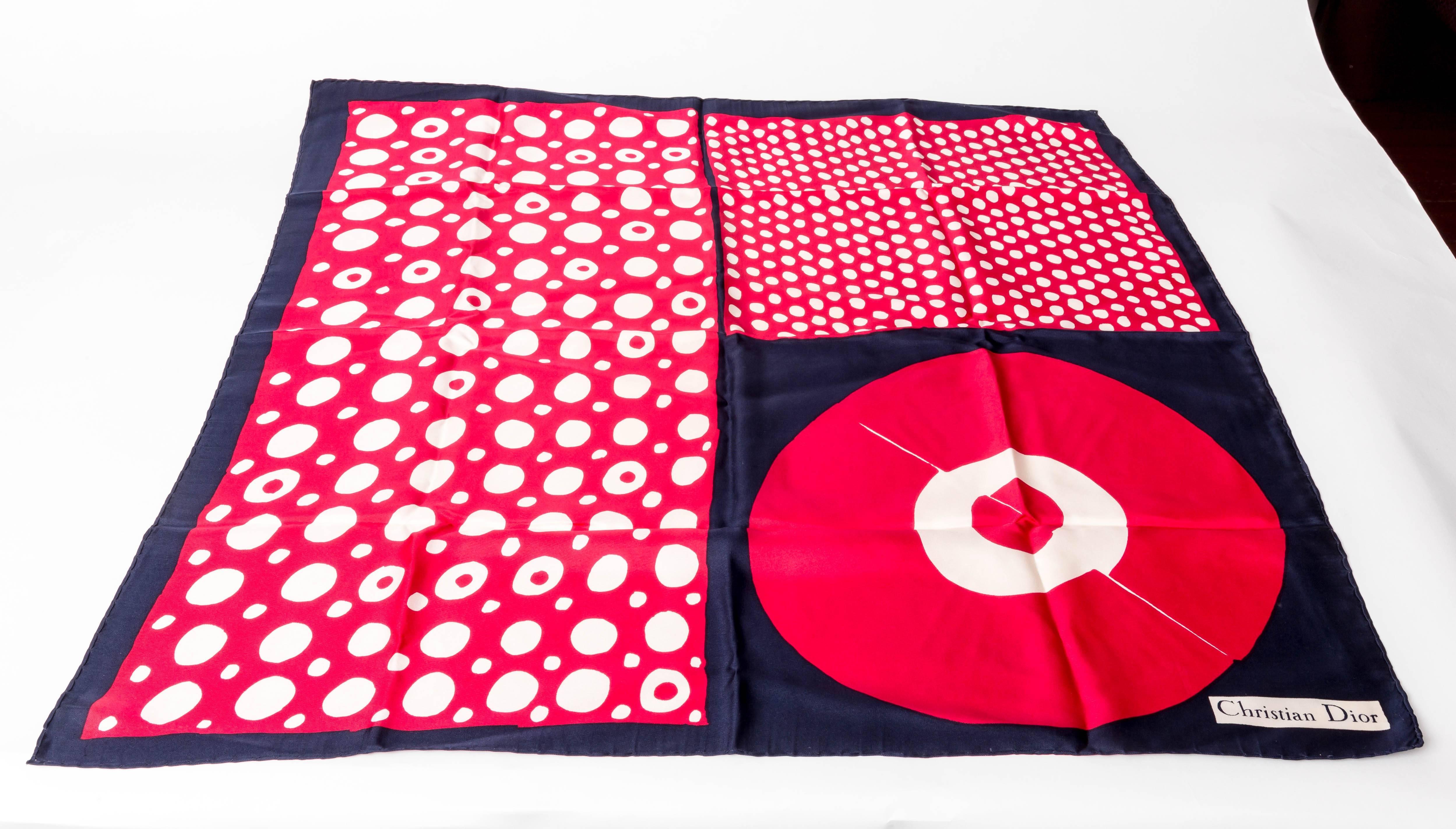 Christian Dior red, white and blue silk scarf with rolled hem. This modern scarf features a navy blue border with a circle theme throughout. Measures 30 x 30 inches.