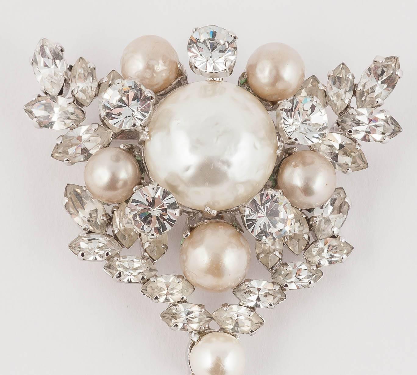 This is a pristine Dior brooch made in Germany by Henkel and Grosse in 1961. It has a wonderful leaf like paste frame for the hand set and dangling baroque pearls.  It would be a brilliant starting point for a wedding dress. Equally it would look