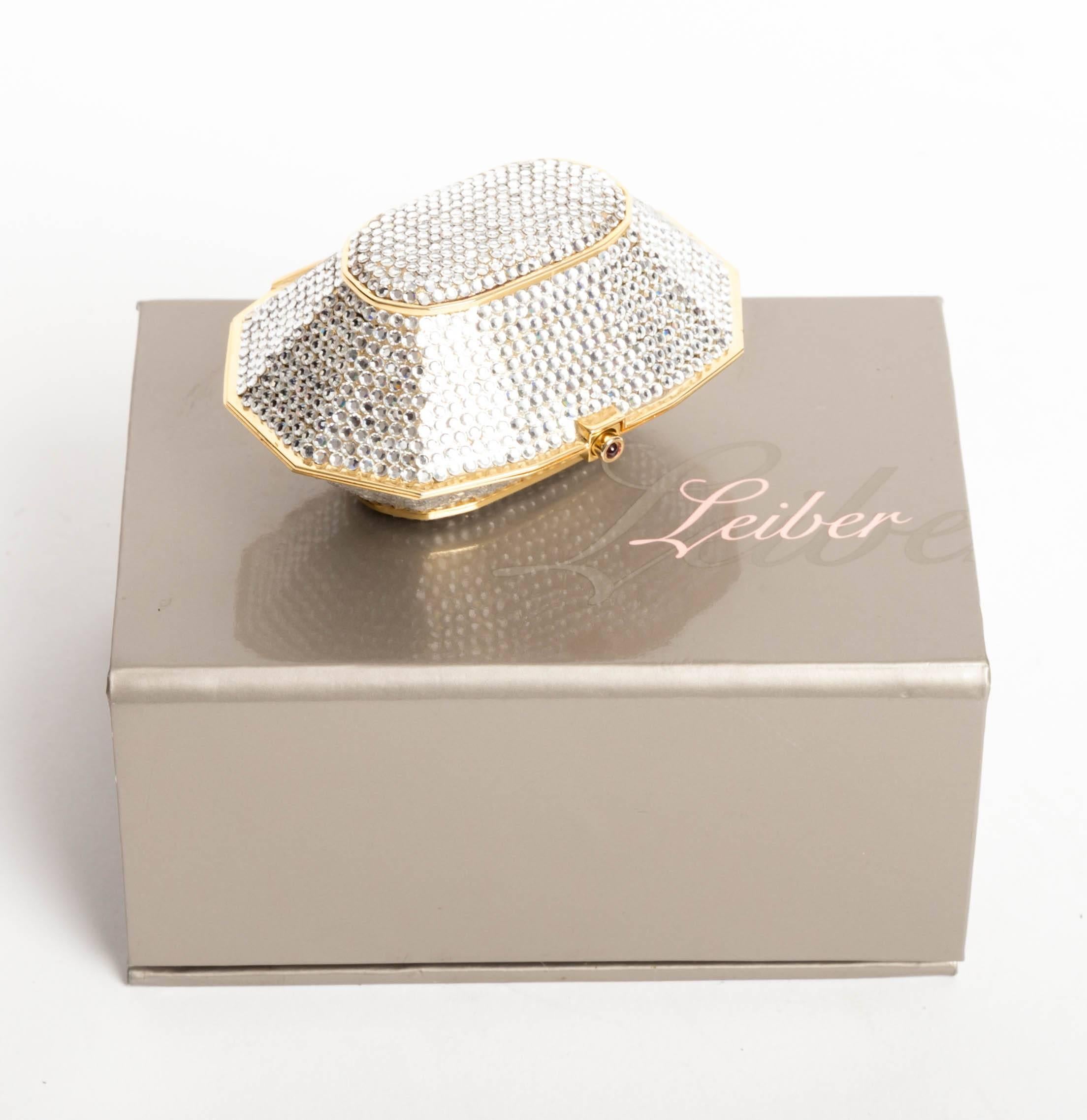 Stunning Judith Leiber Crystal Pill Box with Quartz Cabochon Clasp and Lined with Gold Leather.
Immaculate condition. No missing stones.
Original Box is Included.