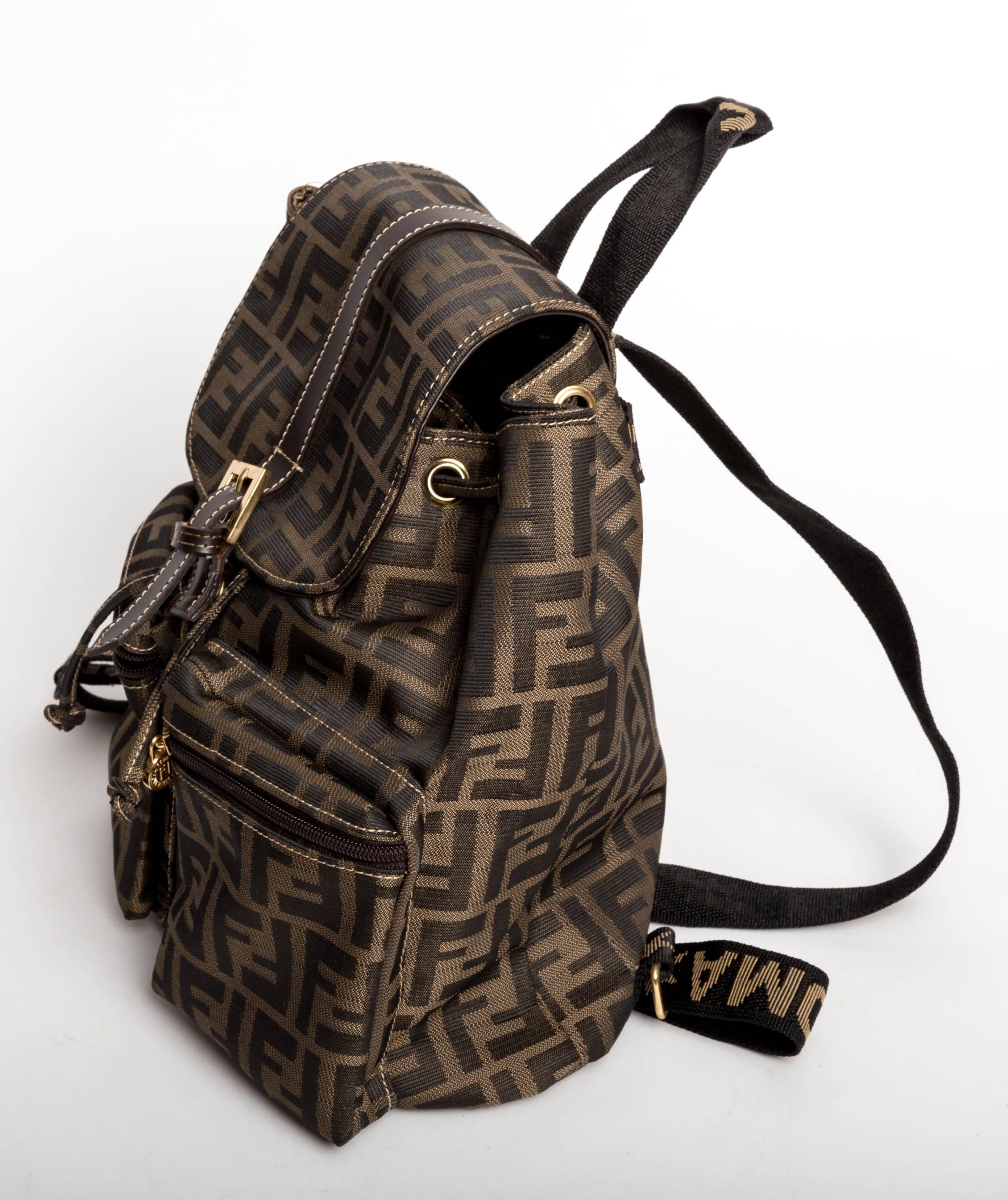 Wonderful Fendi Zucca Backpack.
Canvas straps and brown leather trim accent this fun backpack with two front zip pockets.

