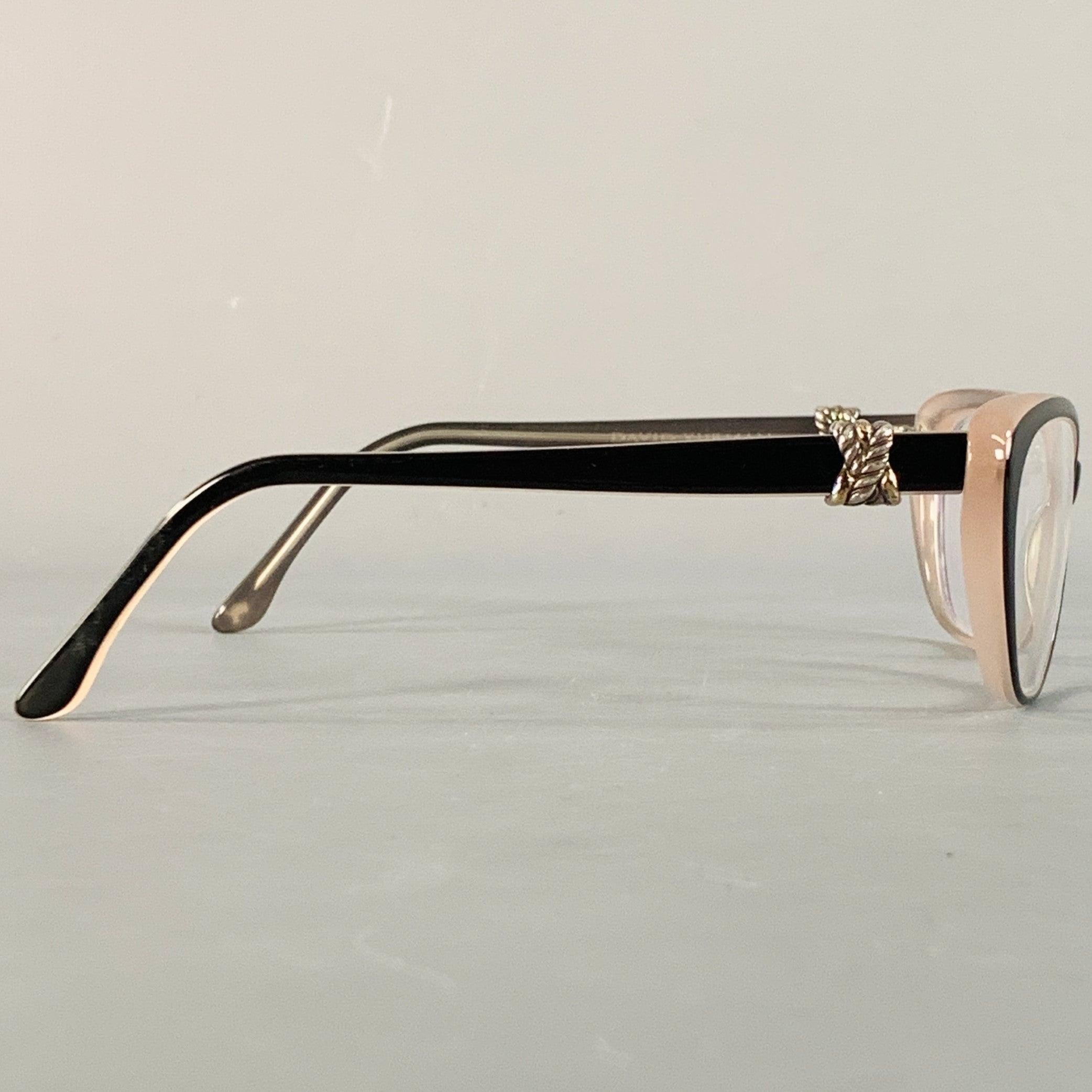 DAVID YURMAN frames
in a black and beige acetate featuring silver tone metal rope embellishments on side, and a narrow cat eye design. Note: these frames contain corrective lenses, which will need to be changed by an optician before wear. Comes with