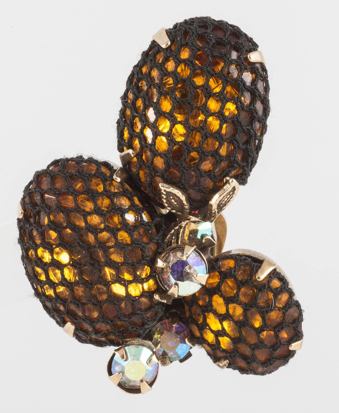 A very unusual and individual look from Kramer for these earrings, made of three large topaz coloured paste stones set in gilt metal, each covered in an elasticated black mesh, with a gilt metal 'leaf',  and irisdescent stones as highlights.The mesh