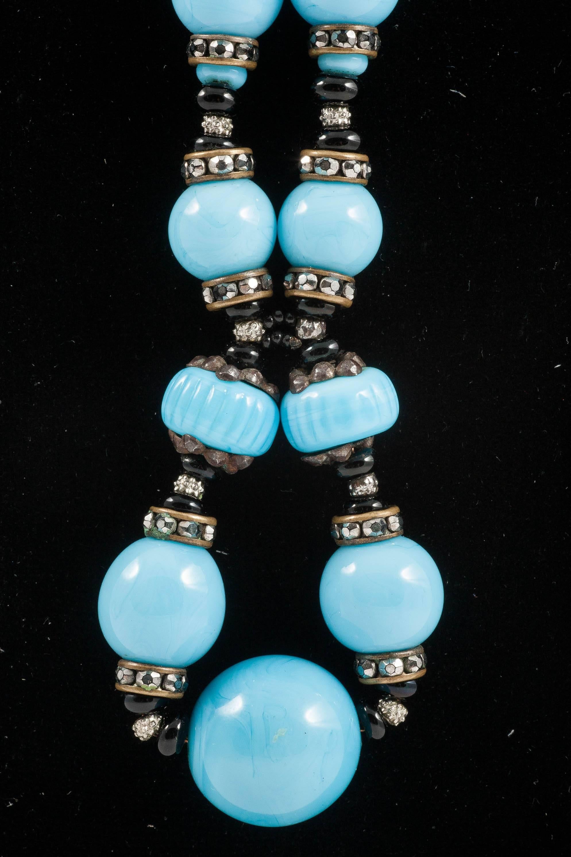 Such a chic design! Black and turquoise glass beads  of assorted shapes and sizes are interspersed with marcasite rondelles, and silver plated caps and spacers, elegantly drawn together two thirds of the way up, and again, nearer the bottome of the