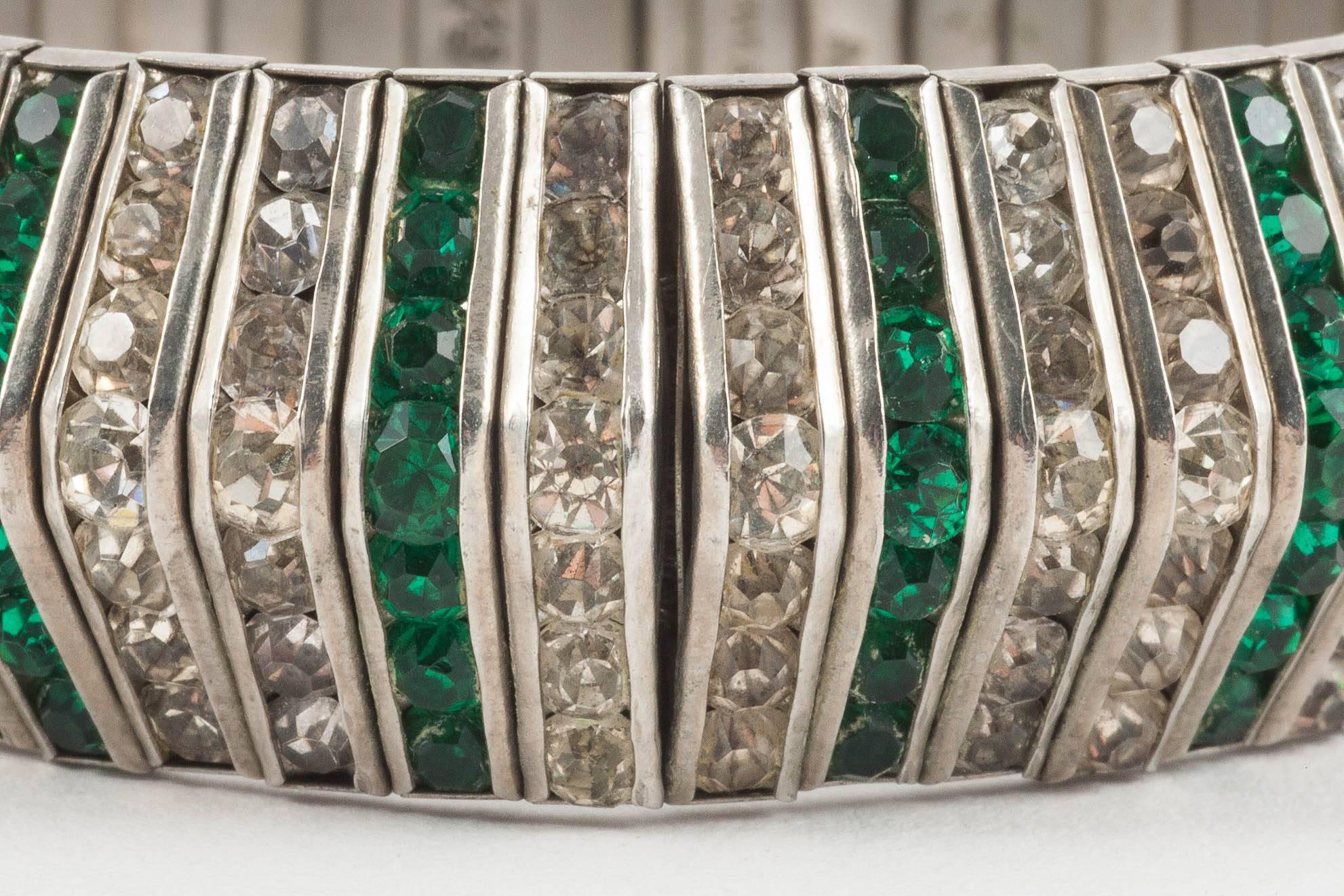 Strong and stylised emerald and clear paste articulated bracelet, signed D.R.G.M, made in Germany in the 1930s, with hidden clasp. This is a fine example and a high style  Art Deco piece - jewellery bearing this mark is always wearable and