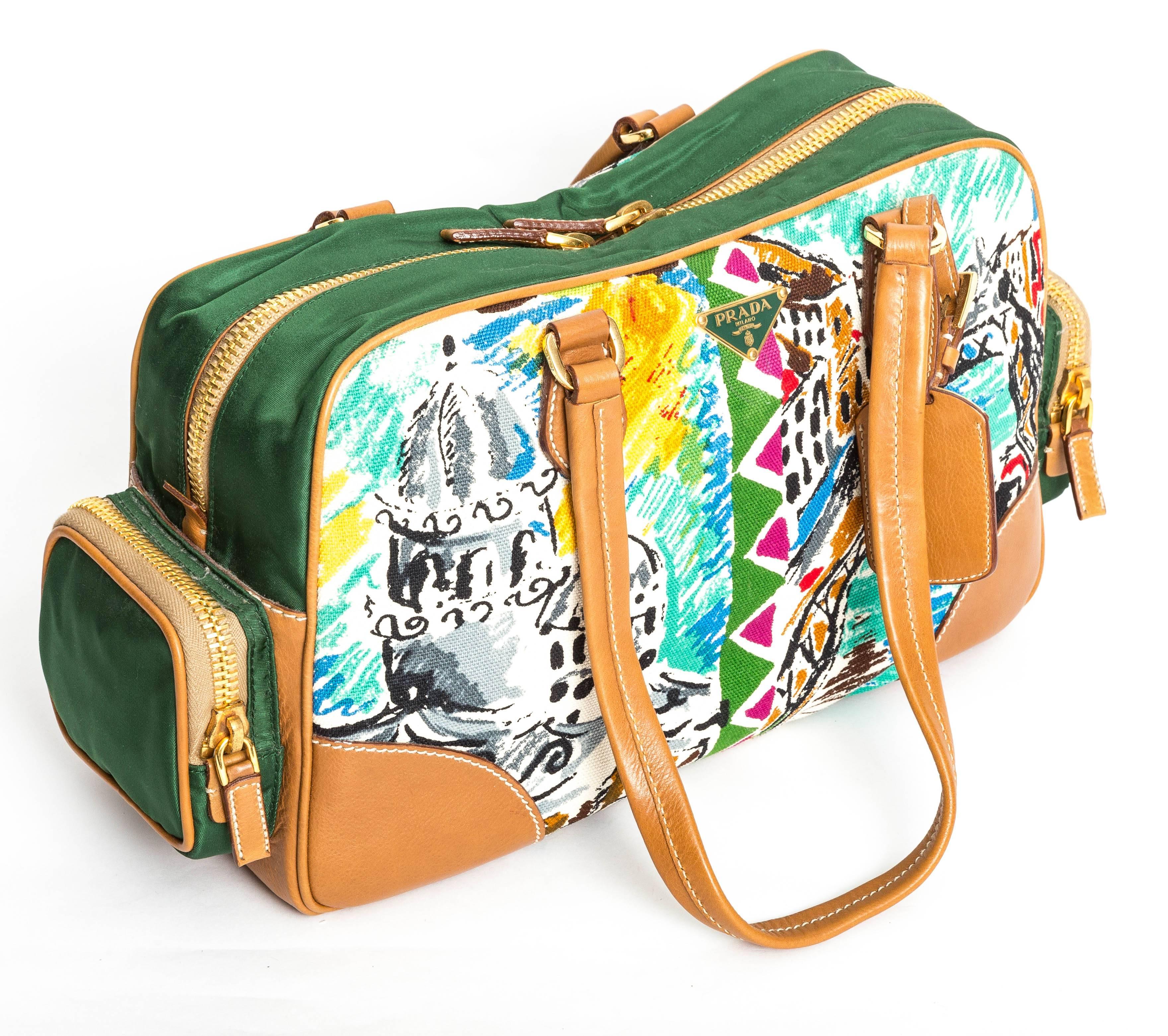Wonderful Vintage Prada Limited Edition Canapa St Venez Bag with Two Green Nylon Zip Pockets and a Printed Canvas Exterior.
Green Logo Nylon Interior with One Zip Pocket.
Tan Leather Handles and Corners.
This bag was purchased at Barney's and still