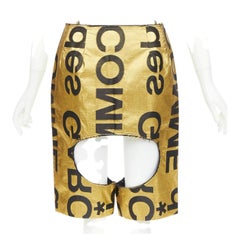 COMME DES GARCONS 2020 Runway gold black polyester silk logo cut out shorts M
