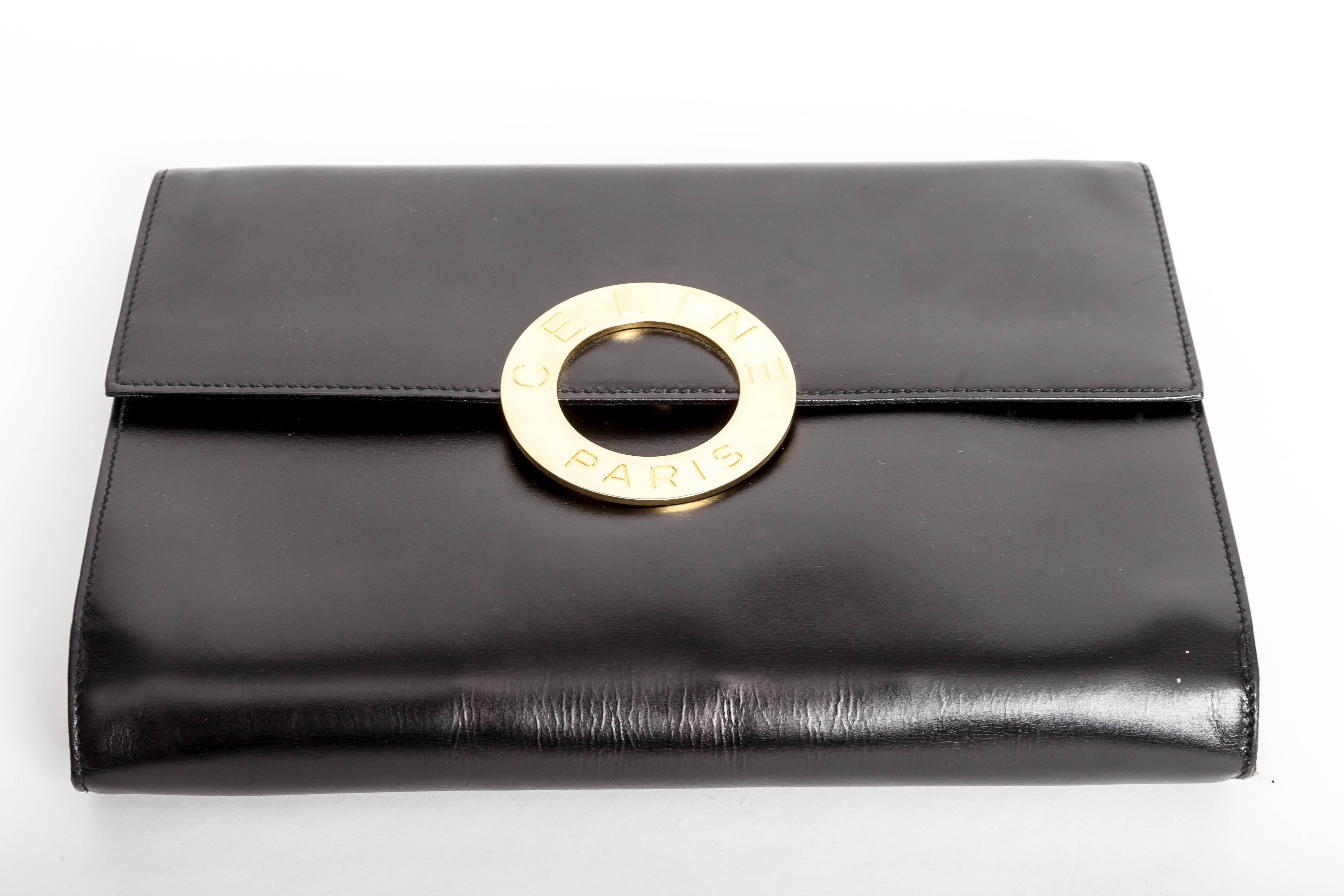 Incredibly chic black leather Celine clutch with detachable shoulder strap.
Lined in red Leather.
Fabulous Gold Celine Clasp.
The leather shoulder strap has caused some marks to the interior of the bag.
A few indentations to the exterior of the