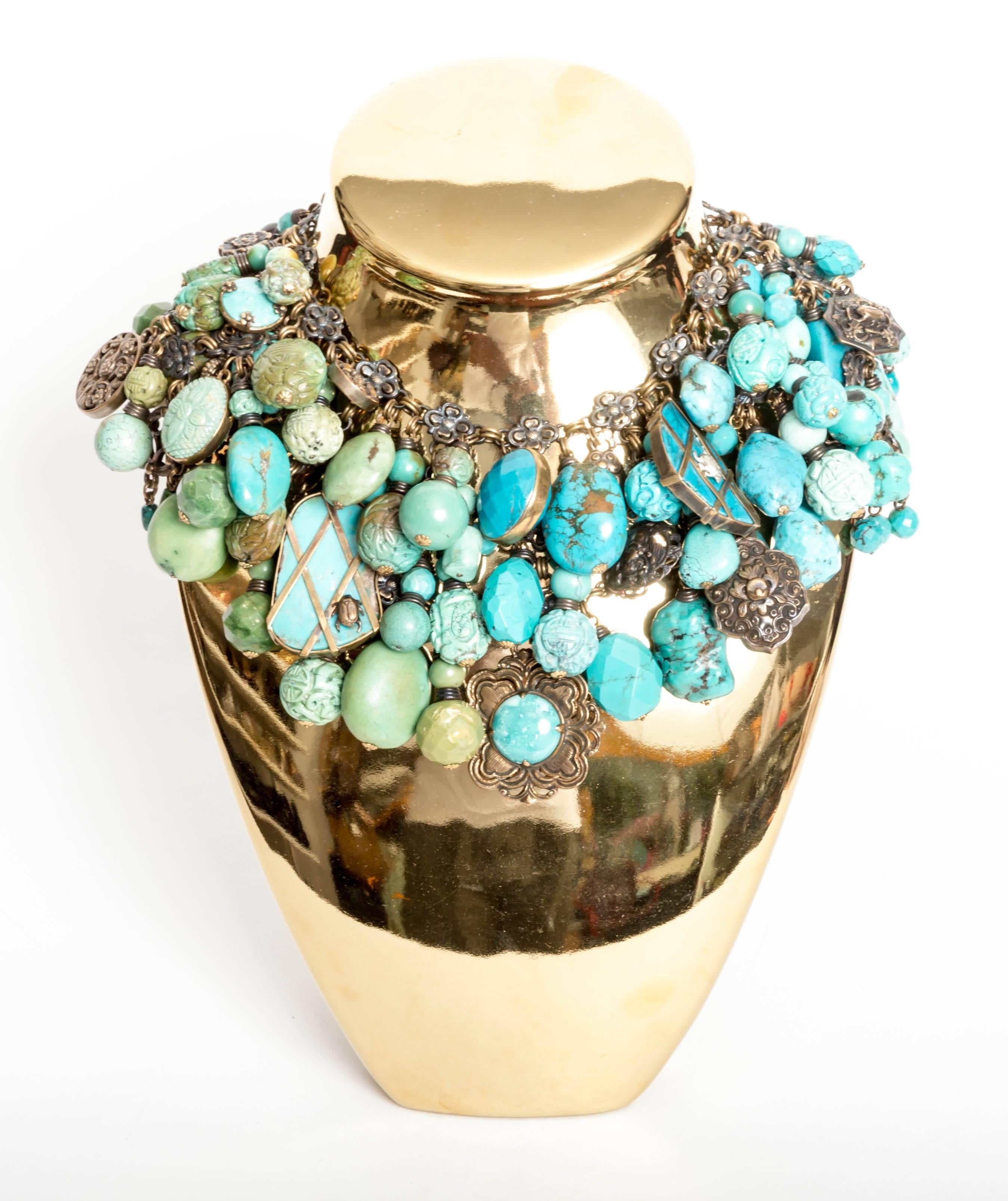 This huge bib necklace by Stephen Dweck is absolutely stunning.
Large textured beads fall from three rows of brass chains.
Carved, faceted and smooth beads comprise this wonderful piece.
This necklace weighs 810 grams.
