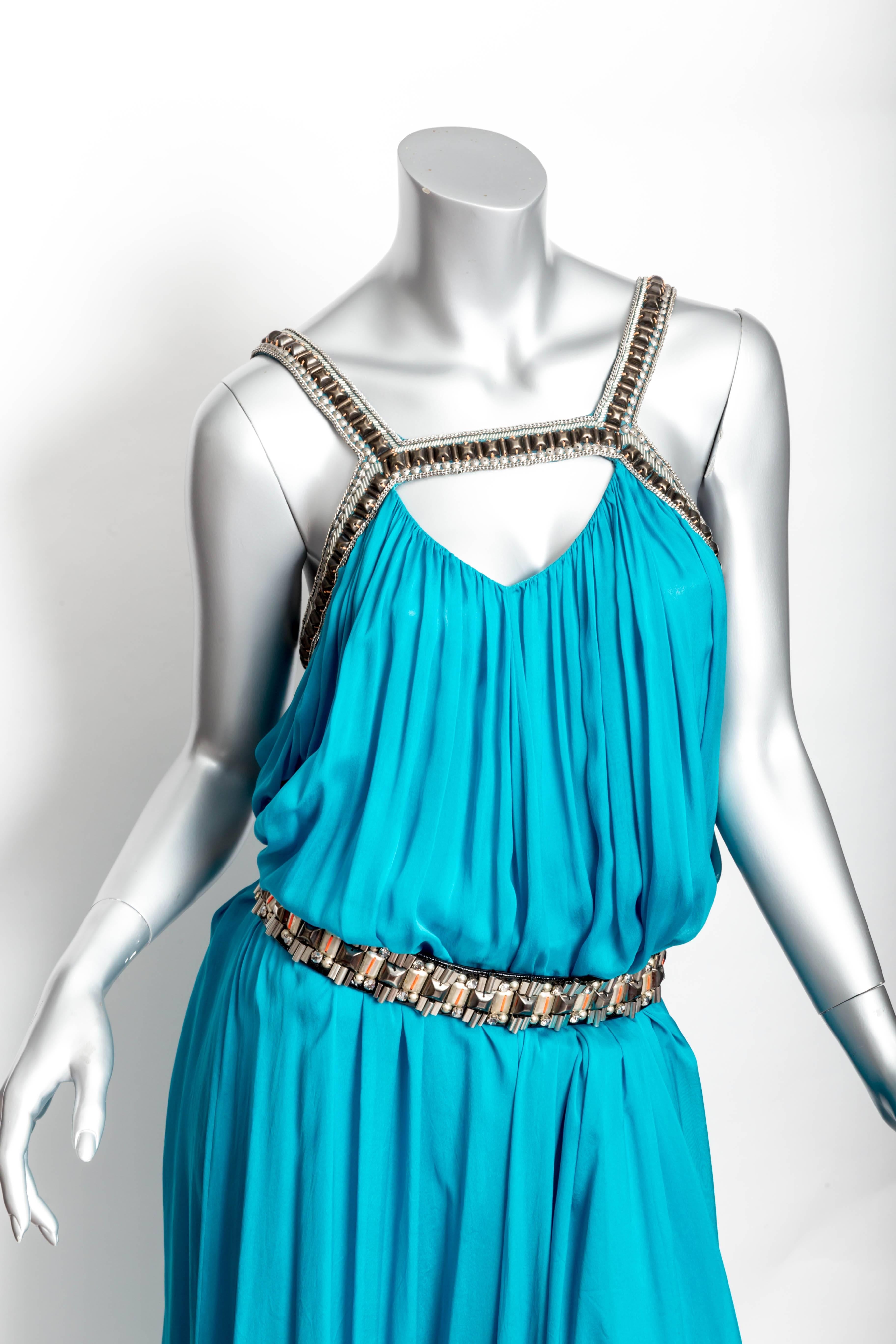 Amazing Matthew Williamson Gown in Turquoise Silk with a Jeweled Neckline and Belt
Belt is a Size 7.5 and is embellished with rhinestones, silver and gold beads and pops of orange stitching 
This is a loose fitting gown and is effortlessly