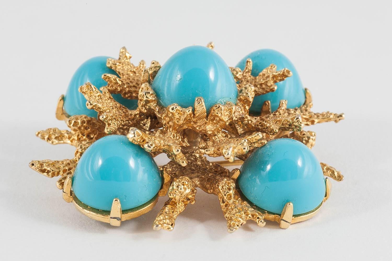 This is a lovely example of 1960s American design. The dome shaped Lucite 'stones' are very high and the gilt surrounds are in a two tier formation, giving this brooch a very 3 dimensional quality. 