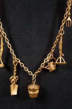 V long matt gilt 'gardening' charm necklace, Karl Lagerfeld, 1990s