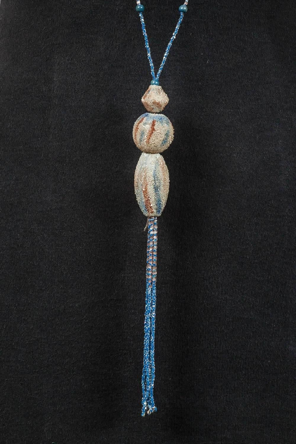 This is such an unusual flapper necklace. in classic 1920s colours of soft peach, sand and blue. The larger beads have tiny beads stuck on in wonderful wave like patterns. It is hard to imagine how this work was done, certainly by hand. This is a