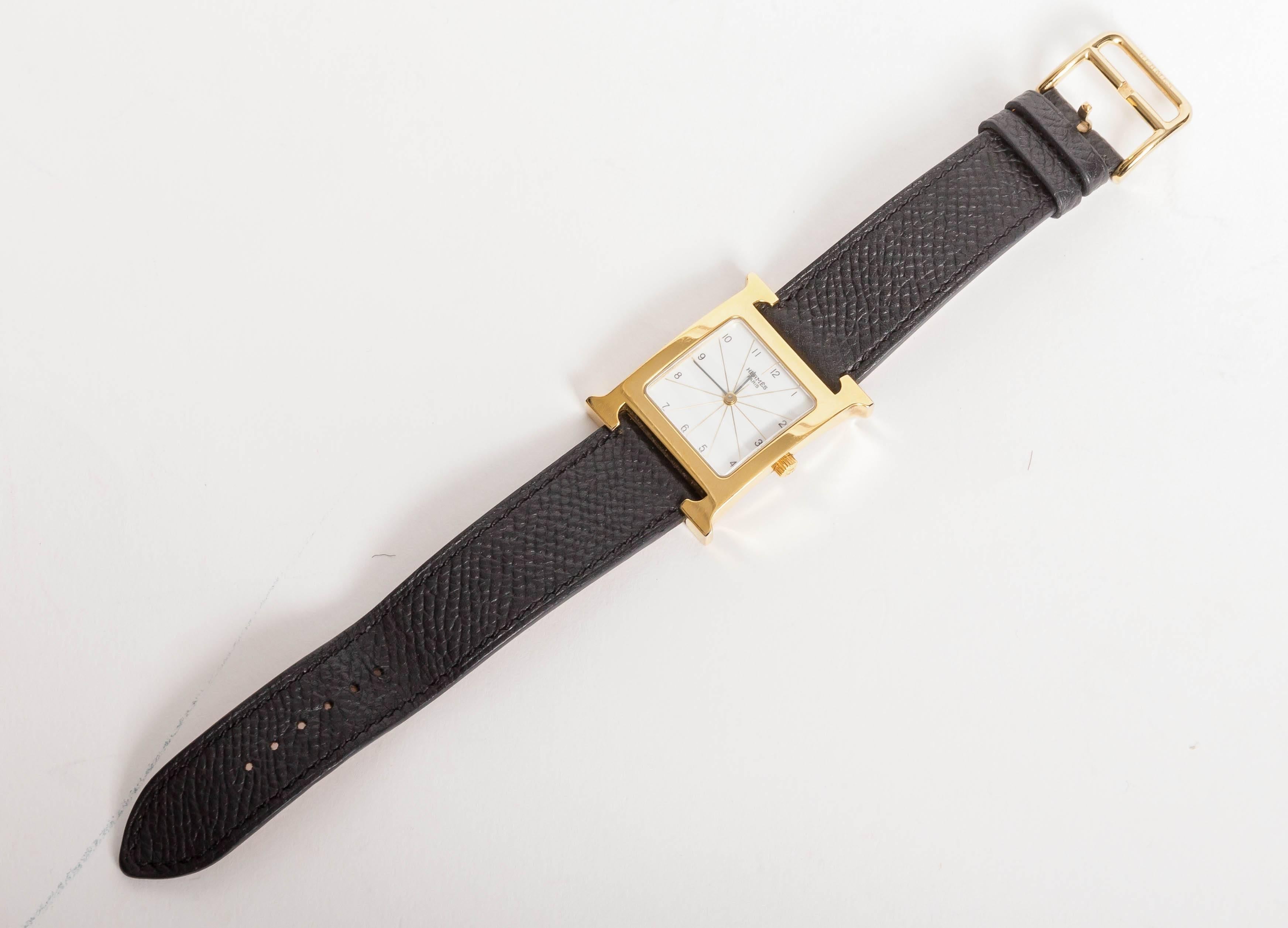 Classic Hermes Heure H Watch in Goldtone Stainless Steel
Model HH1.501
Grained leather strap is blind stamped BRACELET HERMES with N in a square denoting the year 2010.
Does not include Hermes box.
Face measures 21 mm x 21 mm
Excellent working order