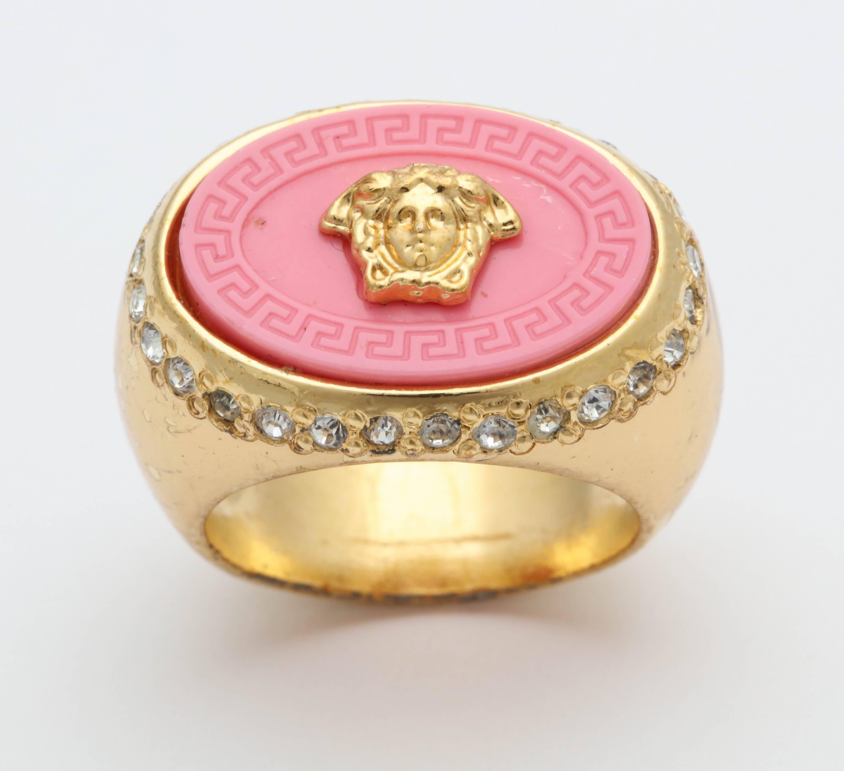 Beautiful Gianni Versace coral pink and gold ring with iconic Medusa motif. 