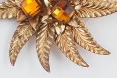 A striking gilt and topaz paste 'sunburst' brooch, Miriam Haskell, USA, 1930s.