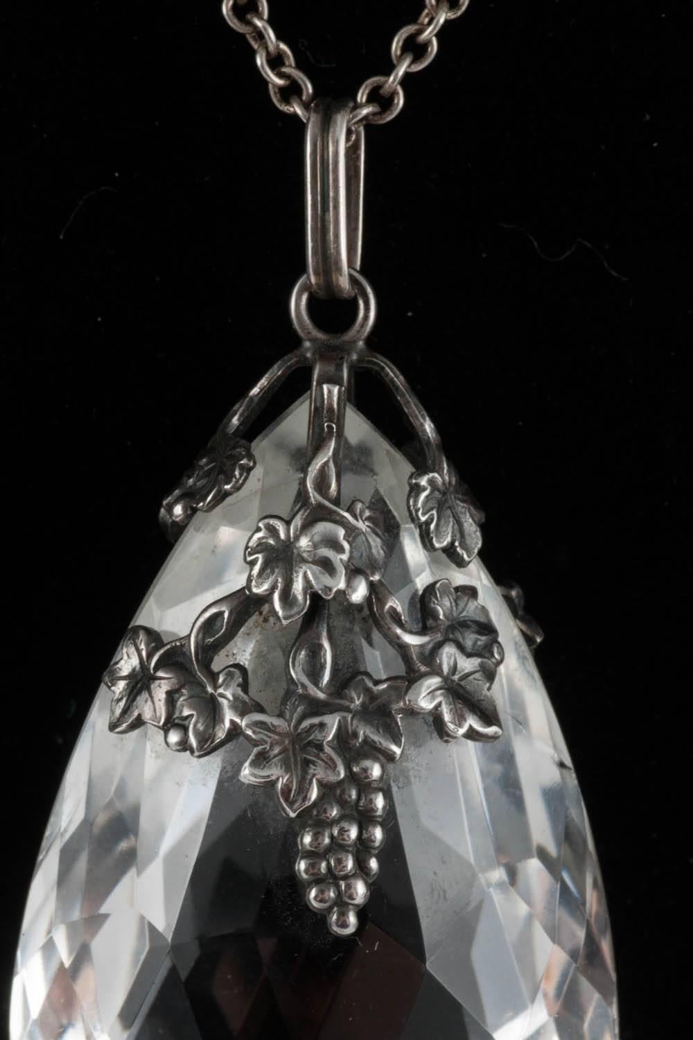 A lovely necklace for Autumn featuring very finely detailed vine leaves and bunches of grapes encasing a large faceted crystal pendant.Hanging from a long sterling silver chain which makes it very wearable for everyday. Both pieces test as silver