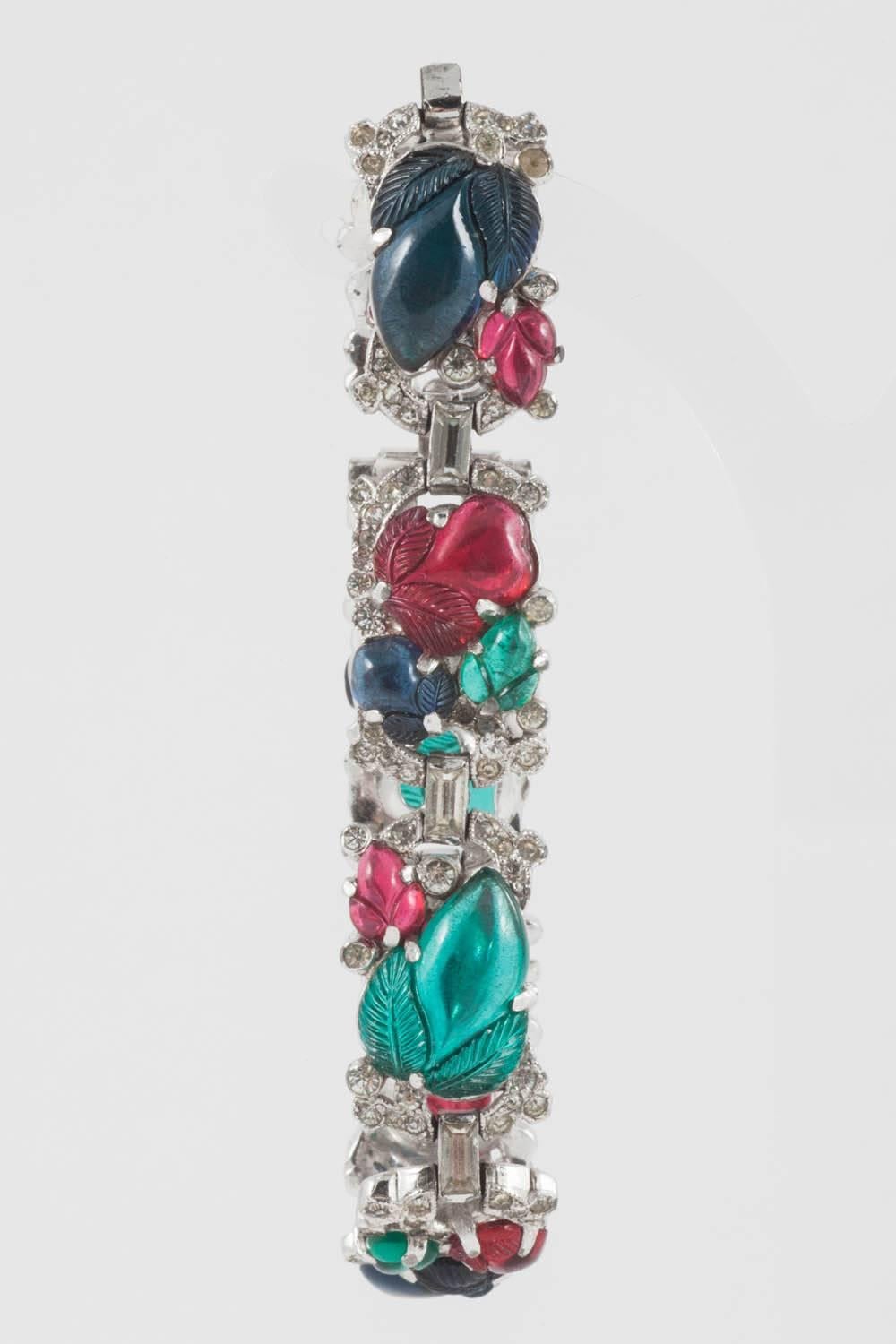 An elegant and simple 'fruit salad' bracelet, in the style of Cartier 'tutti frutti' jewels, from the 1930s, designed by Alfred Philippe for Trifari. The 'fruit' are made from moulded glass,of varying sizes and shapes, with clear pastes, and all set
