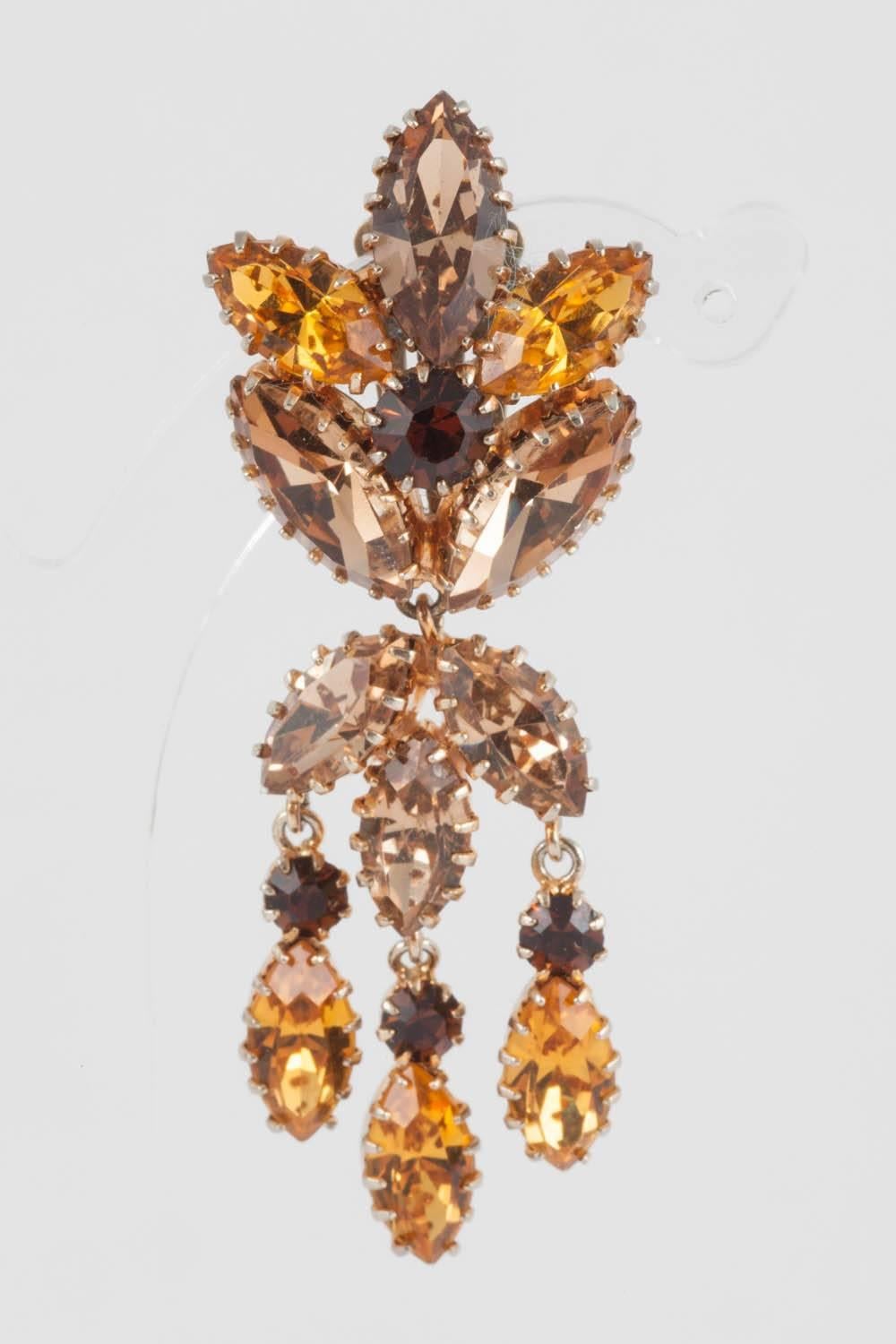 These earrings offer a subtle combination of topaz and citrine coloured pastes, all claw-set in their individual settings. All articulated , with a large foliate top, that sits on the ear, they are perfect for a simple black dress, or for dressing
