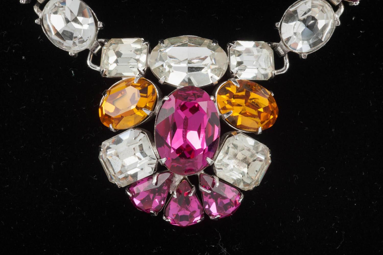 A very pretty necklace in a really unusual and beautiful colour combination of clear, deep pink and topaz/deep citrine pastes of varying shapes and sizes, all set in a white metal setting.
There is something very striking and attractive in this