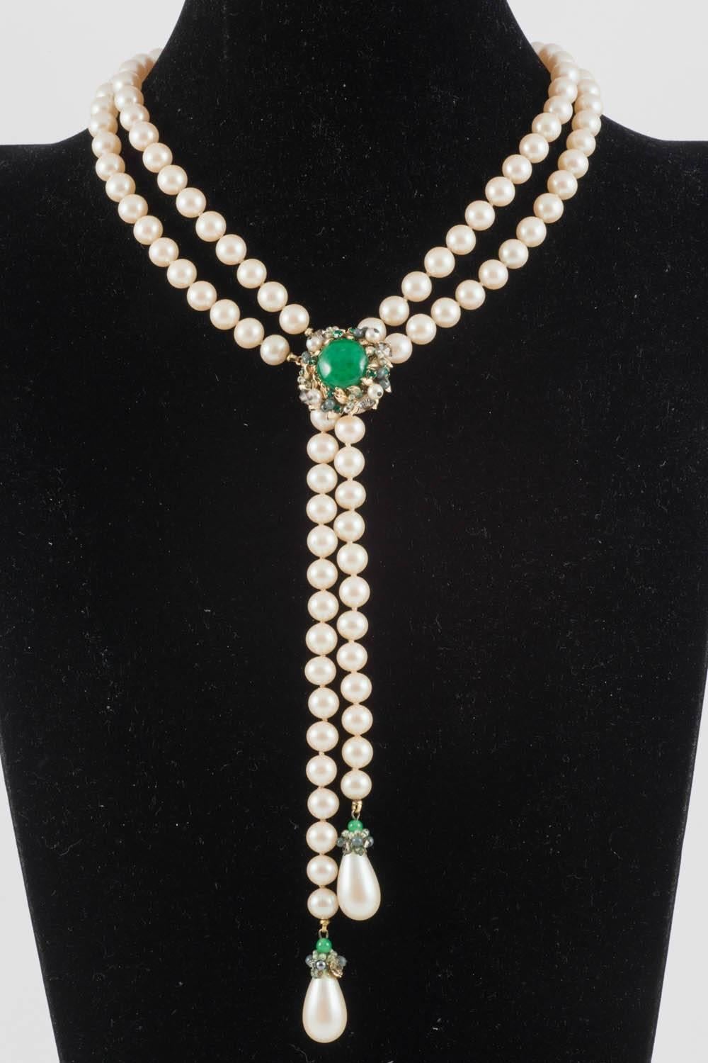 A very smart and elegant faux pearls necklace and matching earrings from Vendome, during the 1960s. The central button on the pearl necklace opens and can be placed up and down the double row, to make the necklace longer or shorter, a useful and