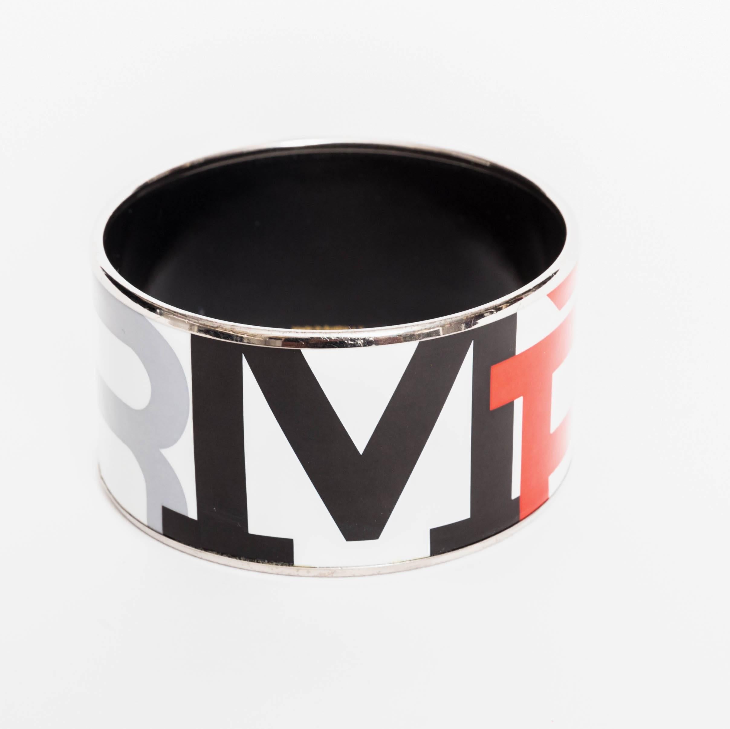 Fabulous Hermes enamel print bracelet - 1.5 inches wide / 2.5 inches in diameter
Hermes is spelled out in red, black, grey and brown.
Exterior Condition is excellent. Enamel shows wear where it meets the silver band on a small portion of the inside