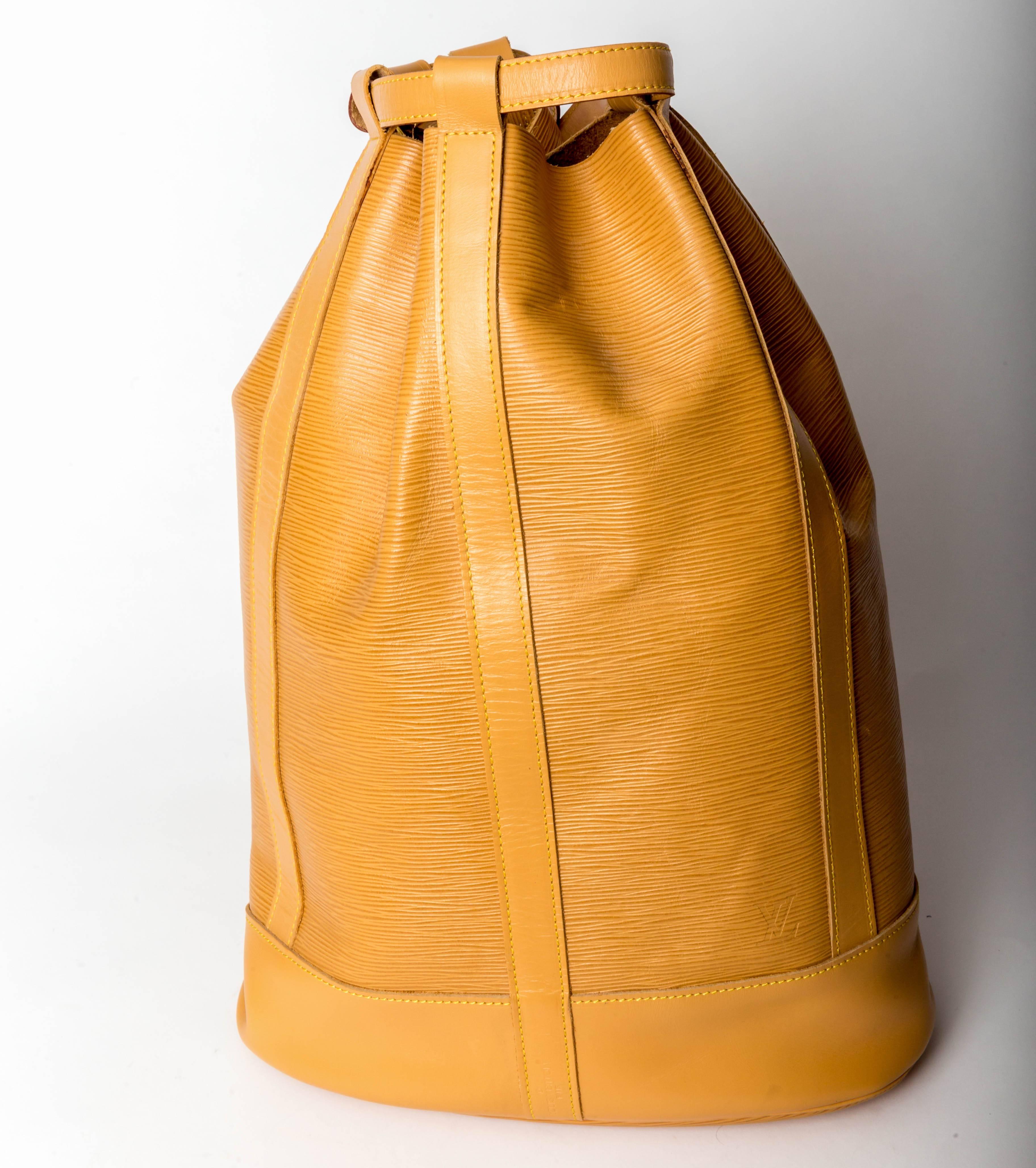 Amazing vintage Louis Vuitton duffel in mustard epi leather
One interior zip pocket
