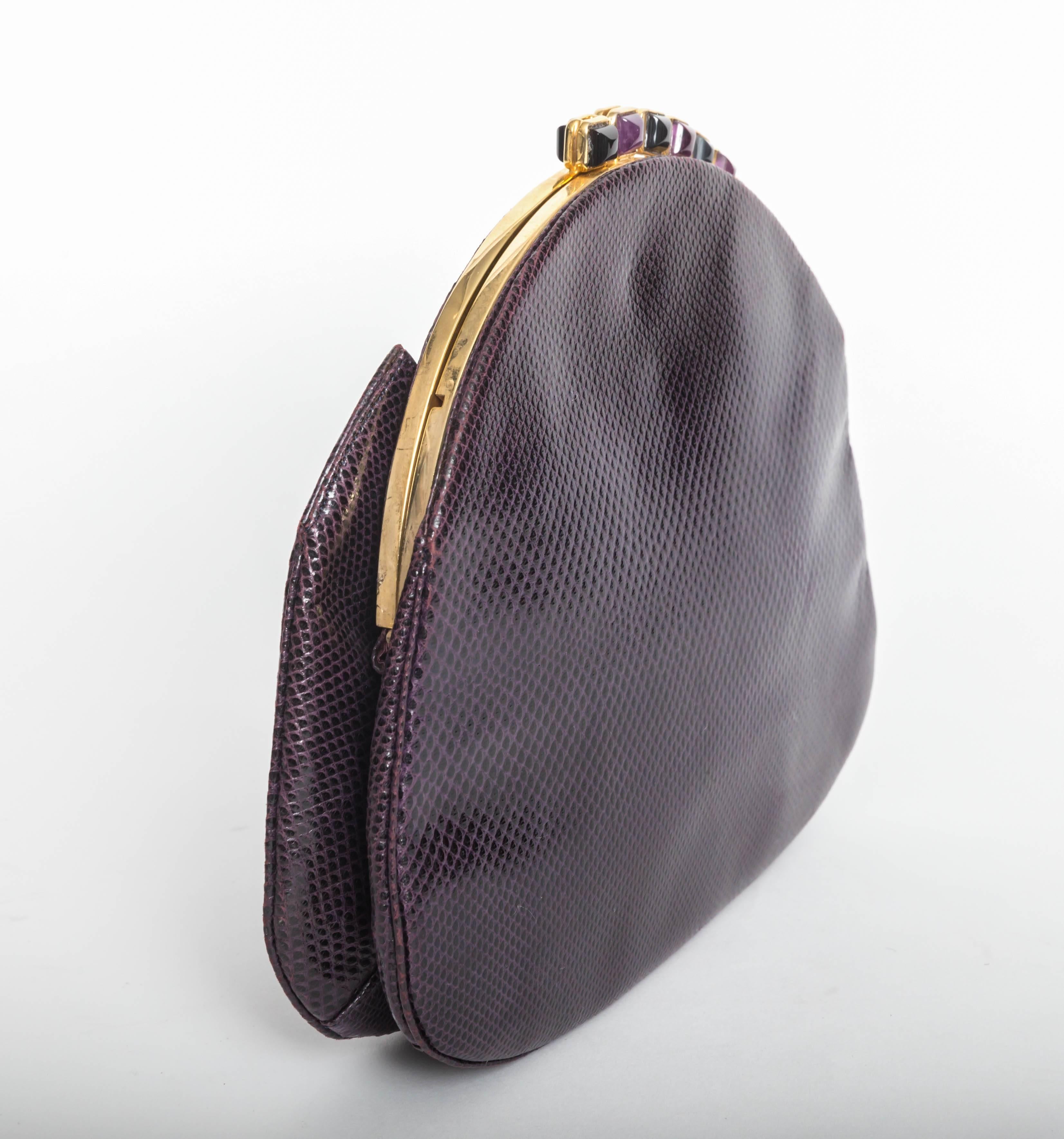 Gorgeous Judith Leiber eggplant clutch with gold chain shoulder strap.
Amethyst and onyx cabochons adorn the top of this bag.
Excellent condition.