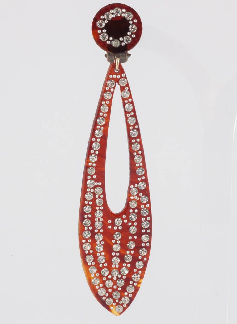 Exquisite and dynamic very long drop earrings, highly typical of the 1920s, with clear pastes set into an imitation 'tortoiseshell' early plastic/celluloid. These benefit from being incredibly light for their considerable size, so old and yet so