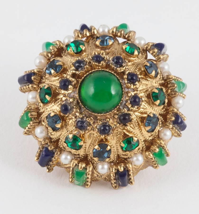 Striking earrings, rich and luscious, baroque, with emerald and sapphire pastes of varying shapes, and paste pearl highlights, set in ornamented gilt metal domes,  with emerald cabuchon centres. They are very glamorous, very wearable  and light!
