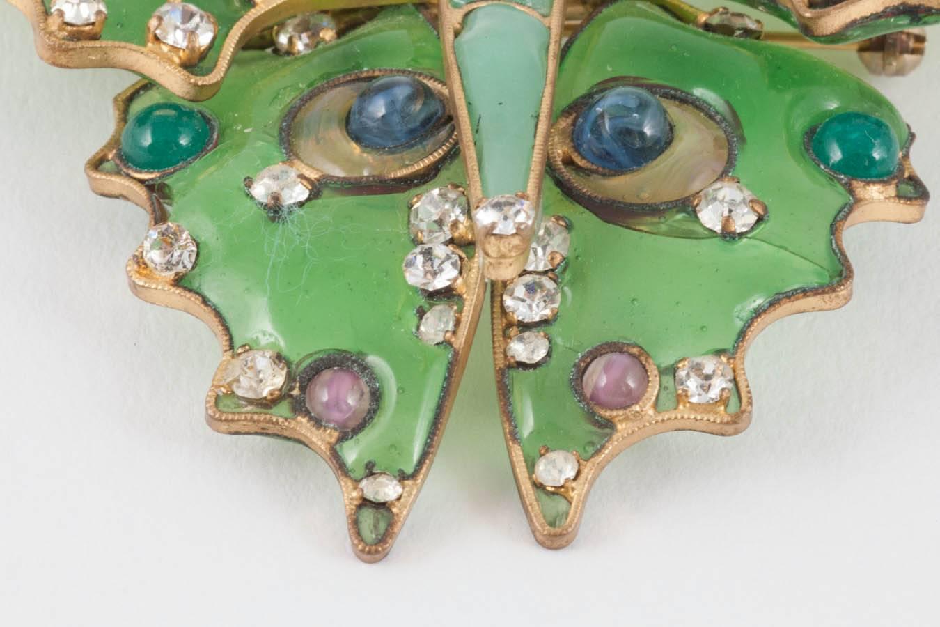 A magnificent beautifully coloured brooch, made in the celebrated atelier of Maison Gripoix. With a gilded metal frame/skeleton, poured glass body, wings and head, and clear paste highlights throughout, this is a luscious piece, handmade by Gripoix